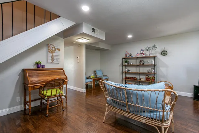 a bedroom with furniture and wooden floor