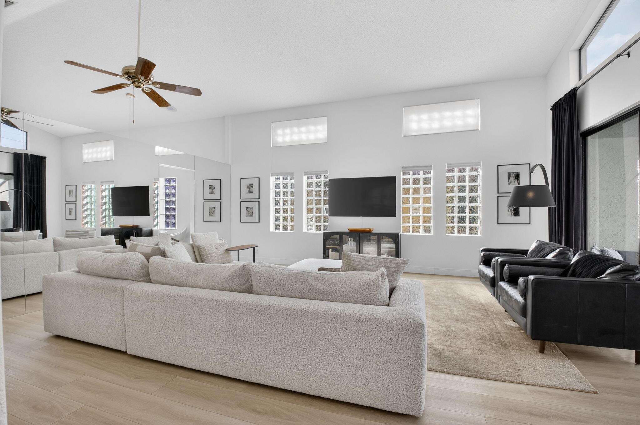 9060 Villa Portofino Circle Boca Raton, FL 33496 - Photo 11 of 47 a living room with furniture and a flat screen tv