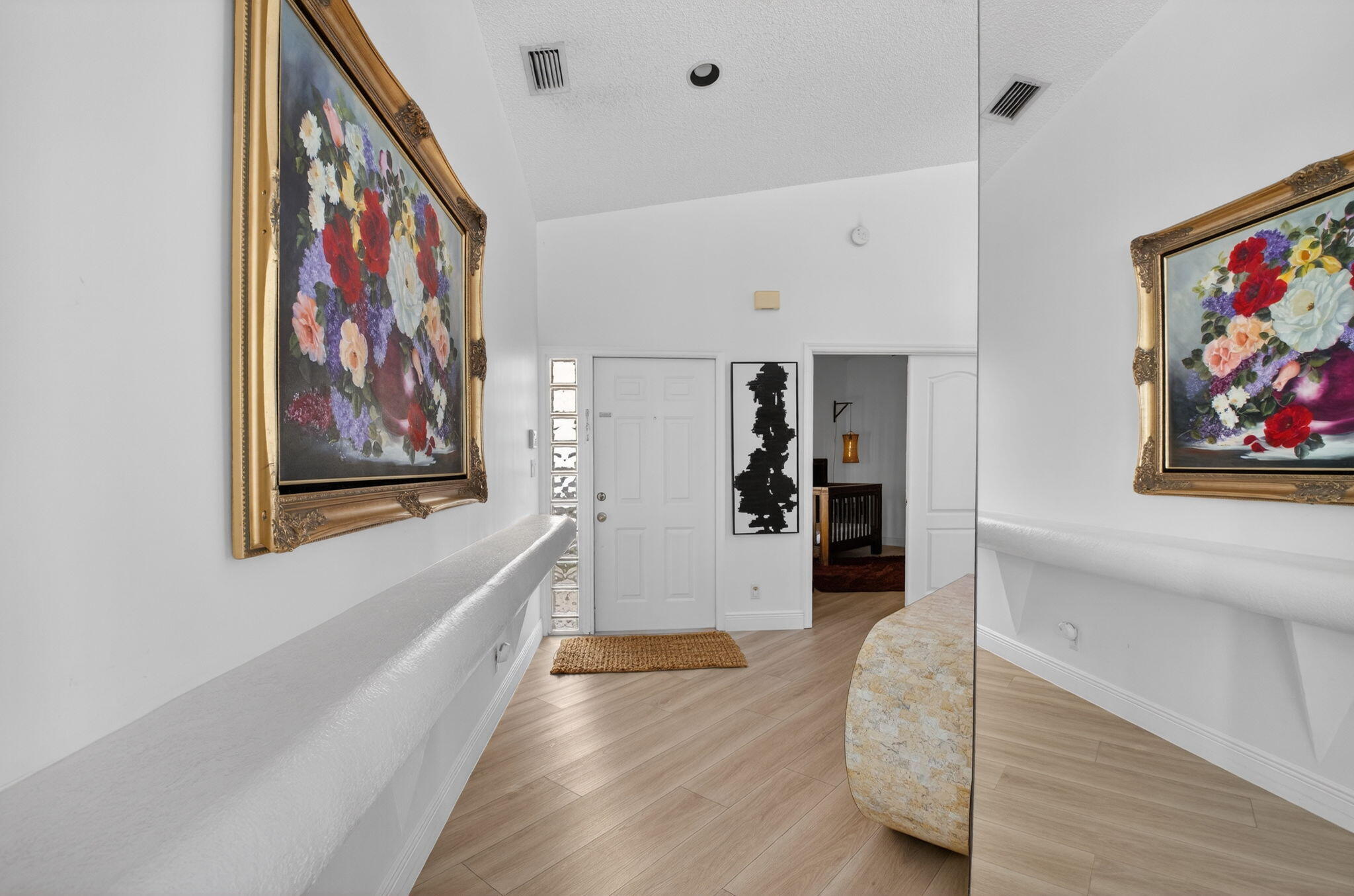 9060 Villa Portofino Circle Boca Raton, FL 33496 - Photo 13 of 47 a view of a hallway with wooden floor and furniture