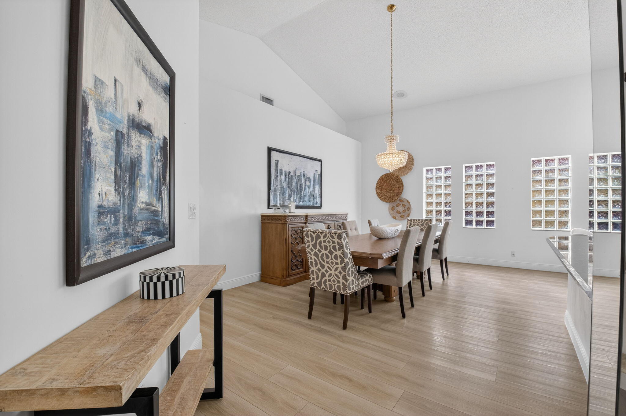 9060 Villa Portofino Circle Boca Raton, FL 33496 - Photo 14 of 47 a view of a dining room with furniture and wooden floor