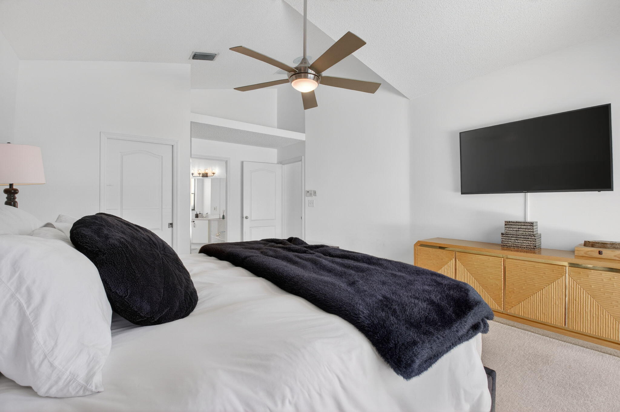 9060 Villa Portofino Circle Boca Raton, FL 33496 - Photo 26 of 47 a bedroom with a bed and a flat screen tv