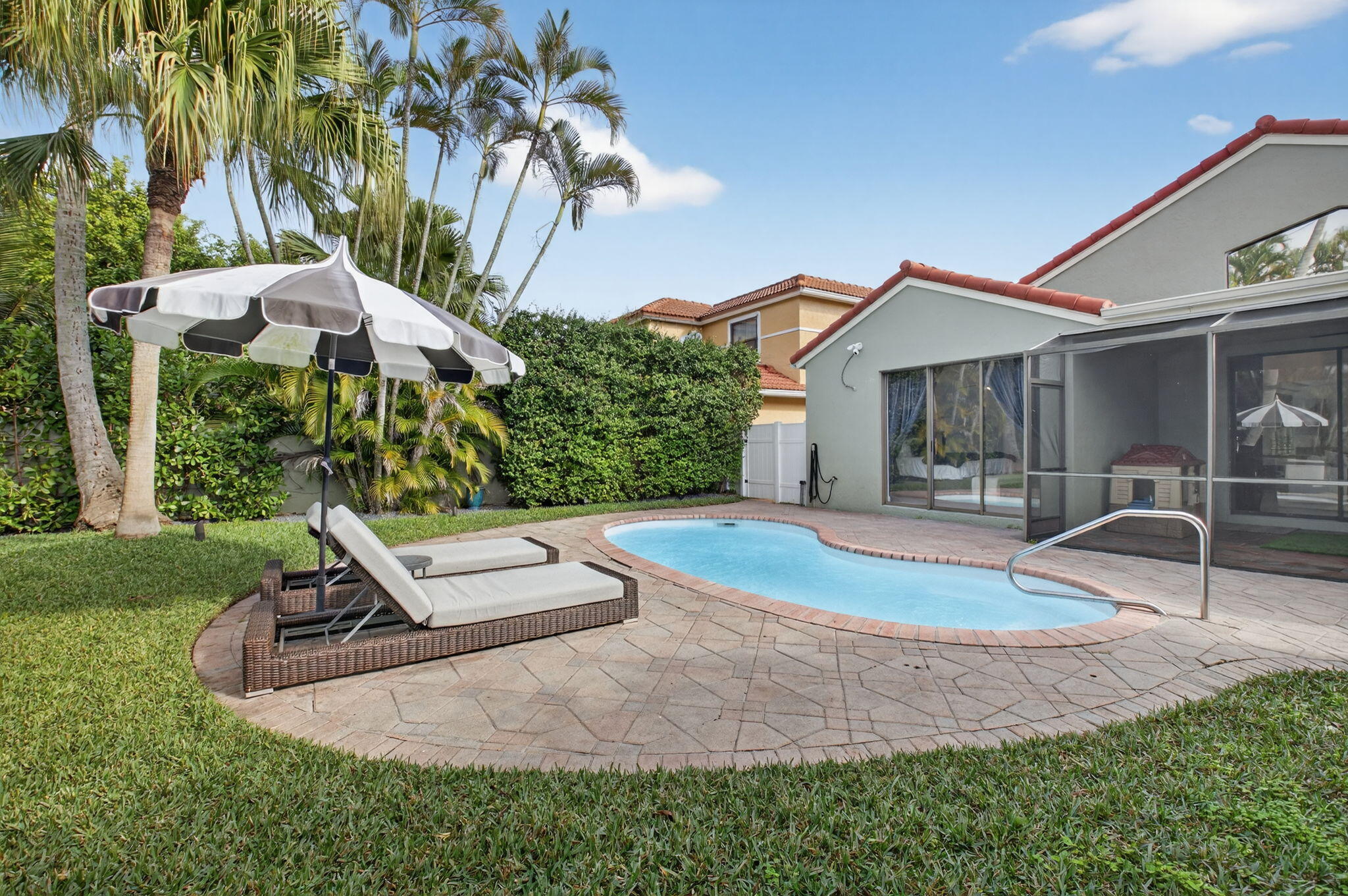 9060 Villa Portofino Circle Boca Raton, FL 33496 - Photo 37 of 47 a view of a backyard with plants and a slide