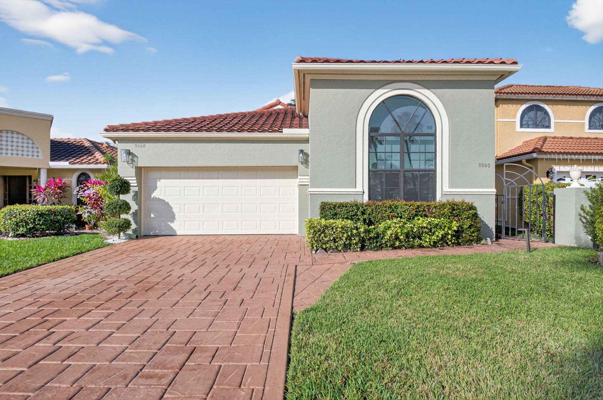 9060 Villa Portofino Circle Boca Raton, FL 33496 - Photo 38 of 47 a front view of a house with garden