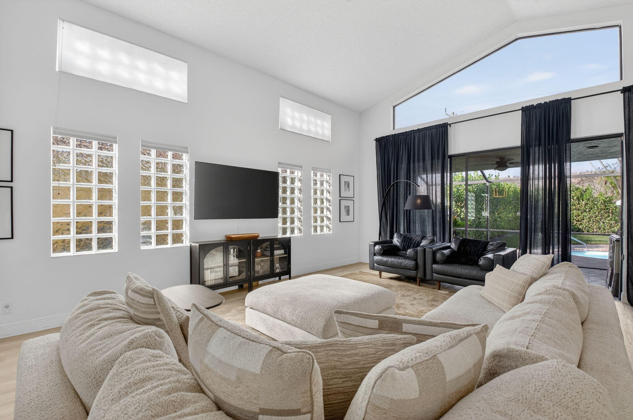 9060 Villa Portofino Circle Boca Raton, FL 33496 - Photo 6 of 47 a living room with furniture tv and large window