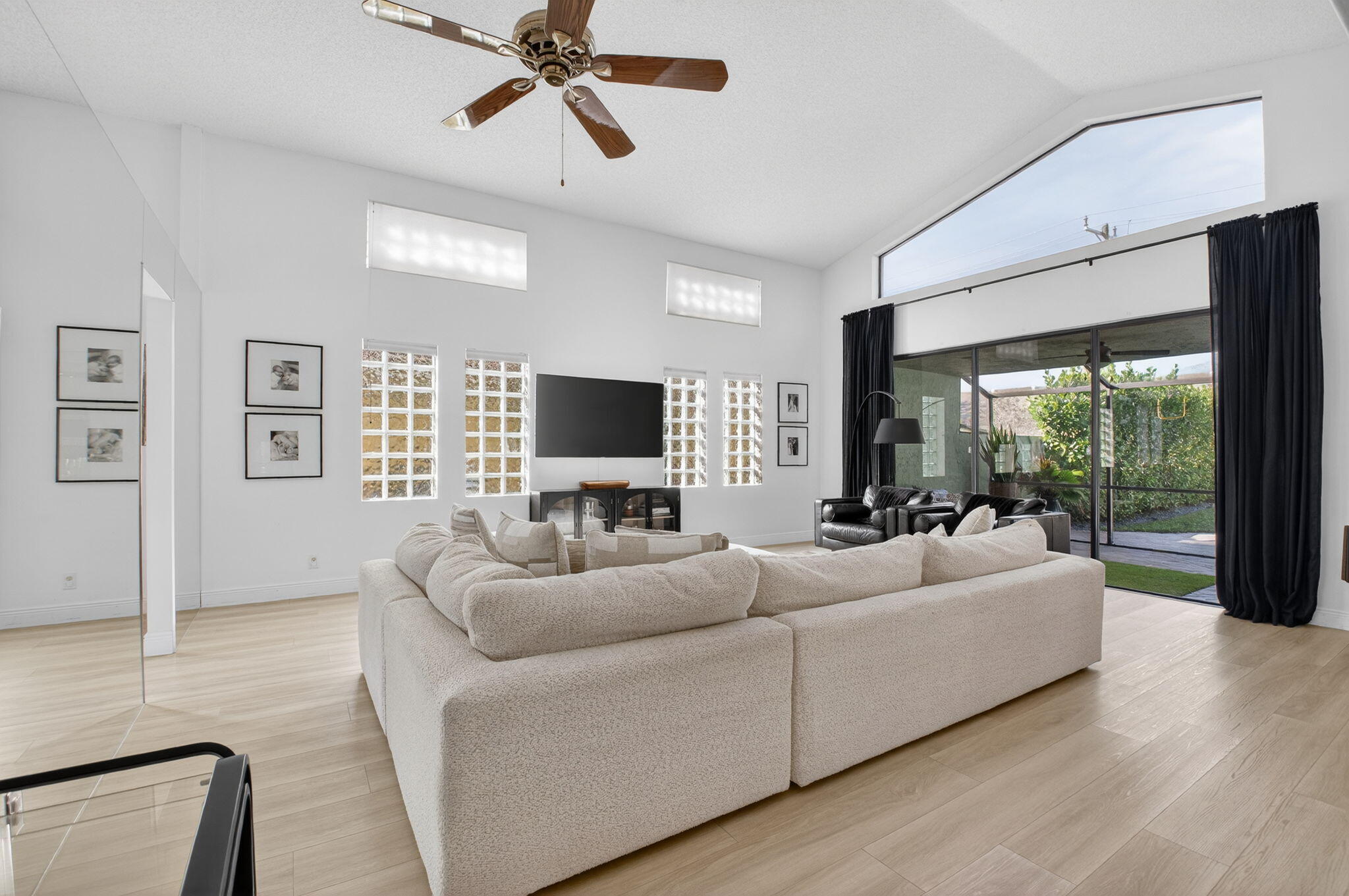 9060 Villa Portofino Circle Boca Raton, FL 33496 - Photo 7 of 47 a living room with furniture and a flat screen tv
