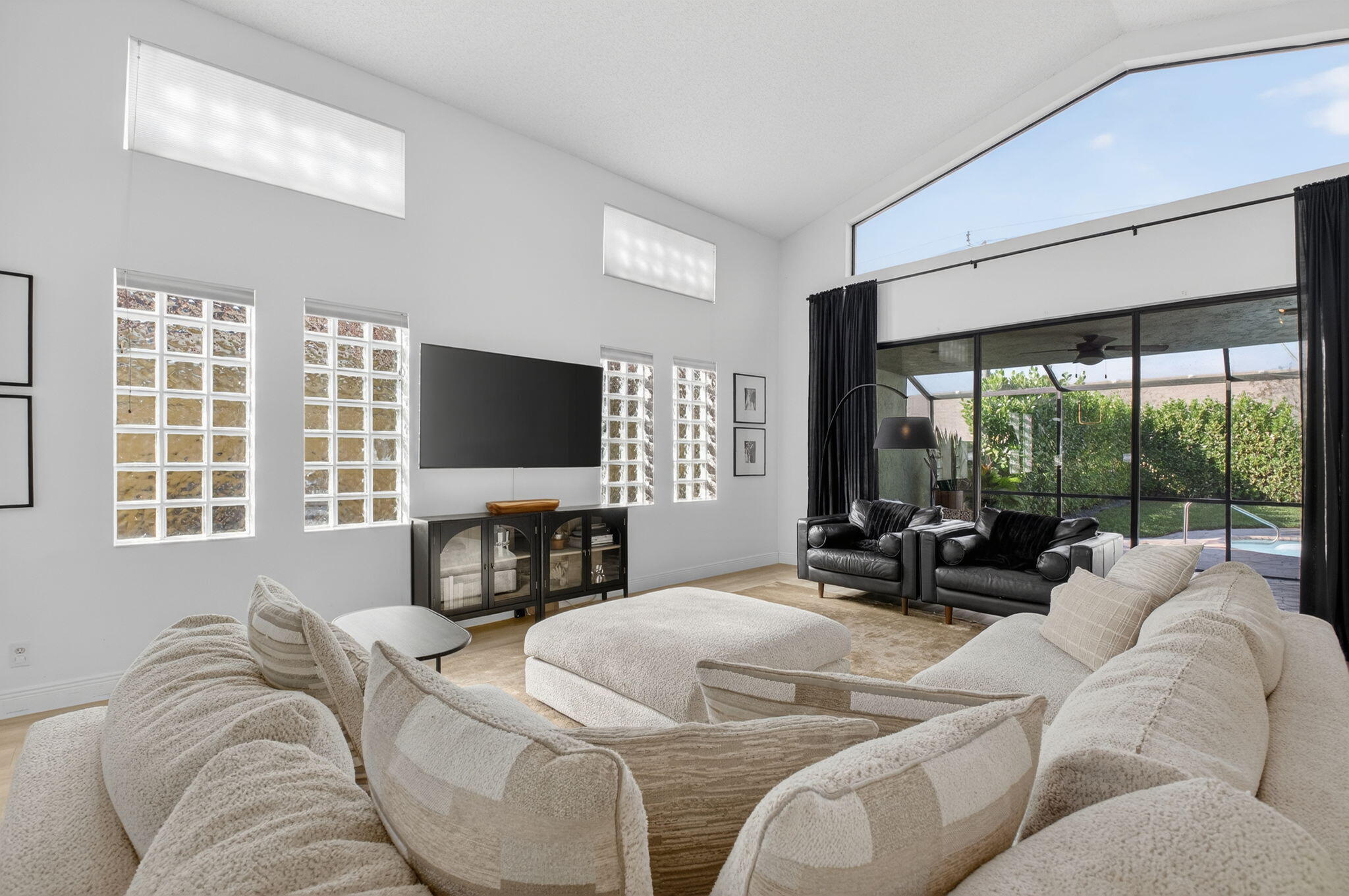 9060 Villa Portofino Circle Boca Raton, FL 33496 - Photo 8 of 47 a living room with furniture tv and large window