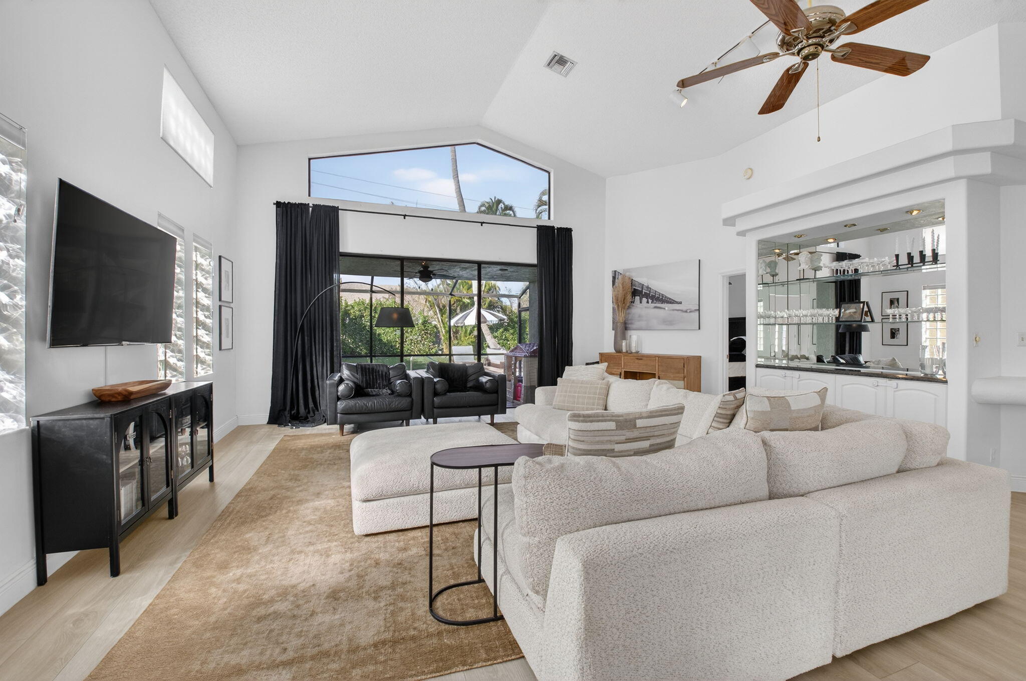 9060 Villa Portofino Circle Boca Raton, FL 33496 - Photo 9 of 47 a living room with furniture and a flat screen tv
