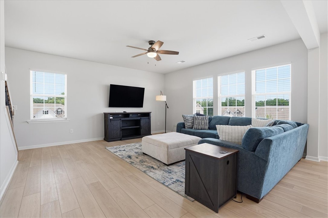 365 Sliding Rock Drive Pendleton, SC 29670 - Photo 8 of 46 A comfortable gathering space features warm wood flooring and ample natural light.