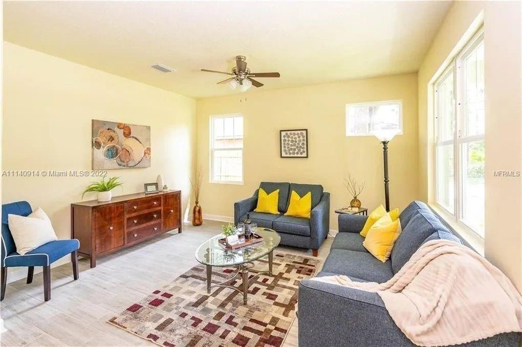 475 Sunset Road North Rotonda West, FL 33947 - Photo 5 of 14 a living room with furniture and a window
