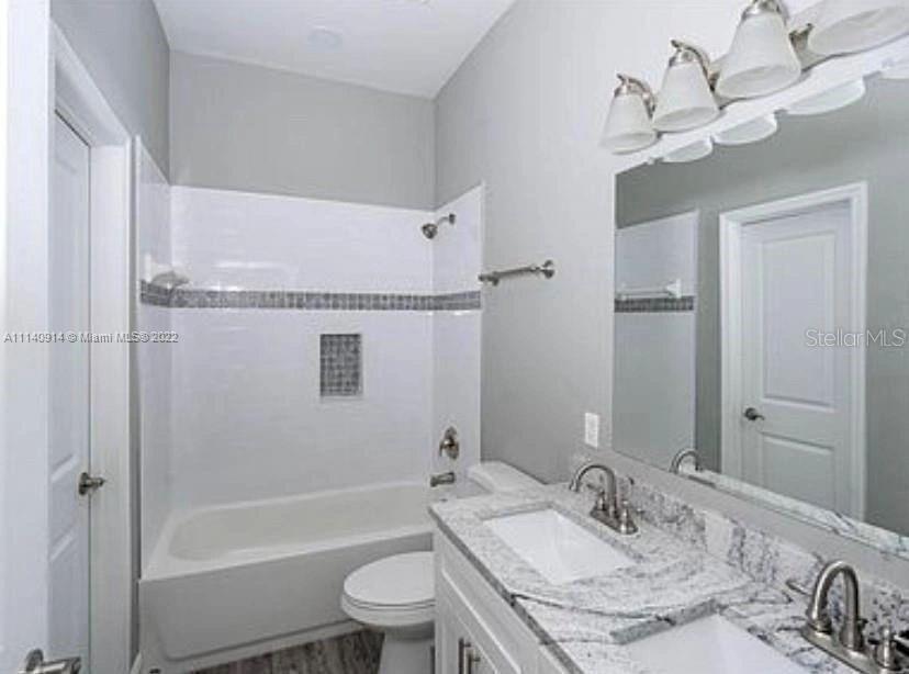 475 Sunset Road North Rotonda West, FL 33947 - Photo 8 of 14 a bathroom with a granite countertop sink toilet and shower