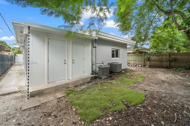a backyard of a house with plants and trees