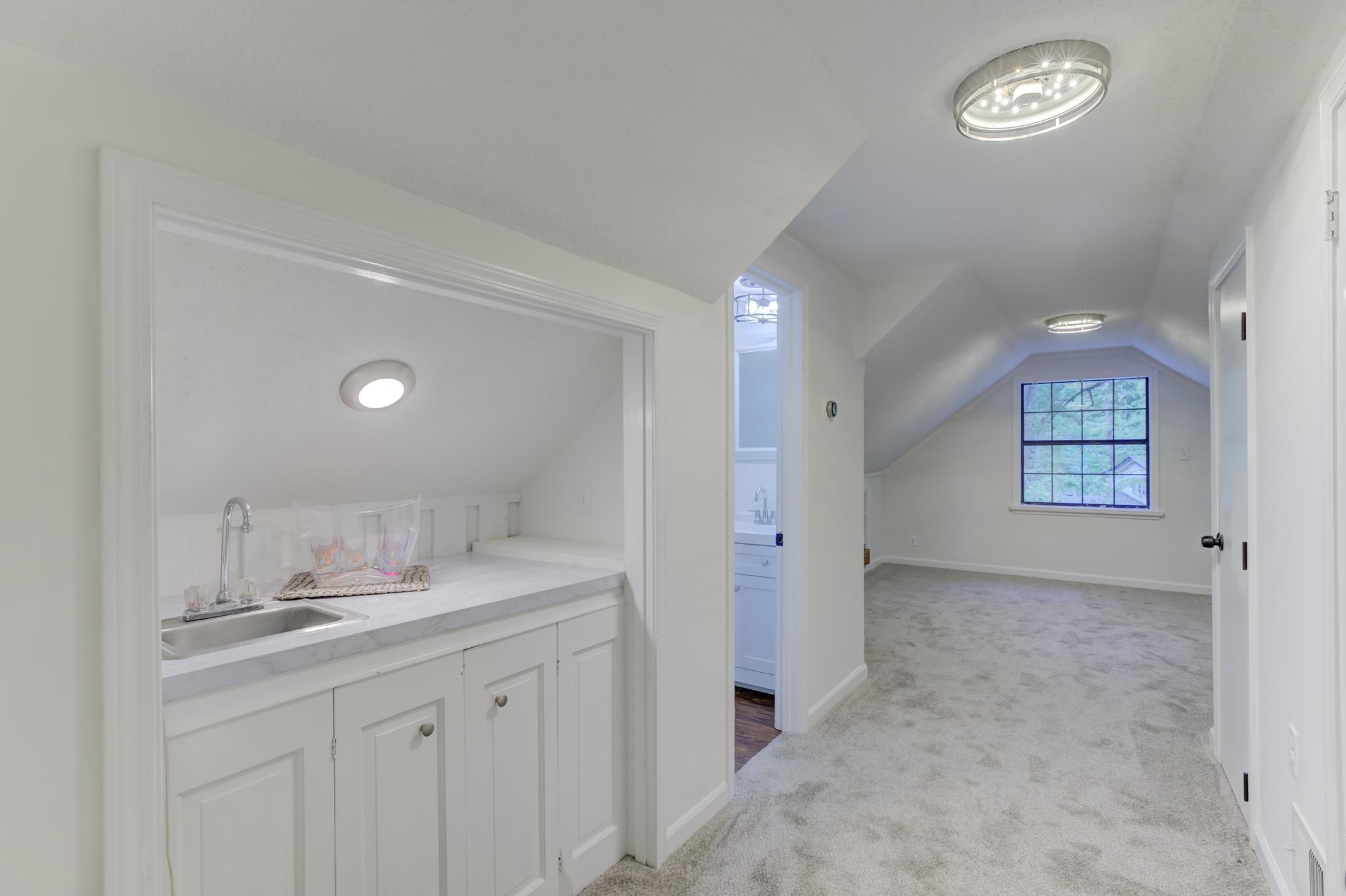 5724 Green Valley Road Memphis, TN 38135 - Photo 17 of 25 Laundry Chute Opening is Under Wet Bar Cabinetry