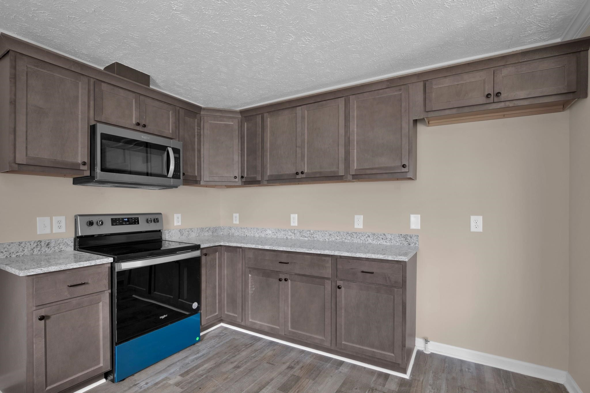 2380 Byrds Mill Road Erwin, NC 28339 - Photo 11 of 36 a kitchen with granite countertop cabinets stainless steel appliances and wooden floor