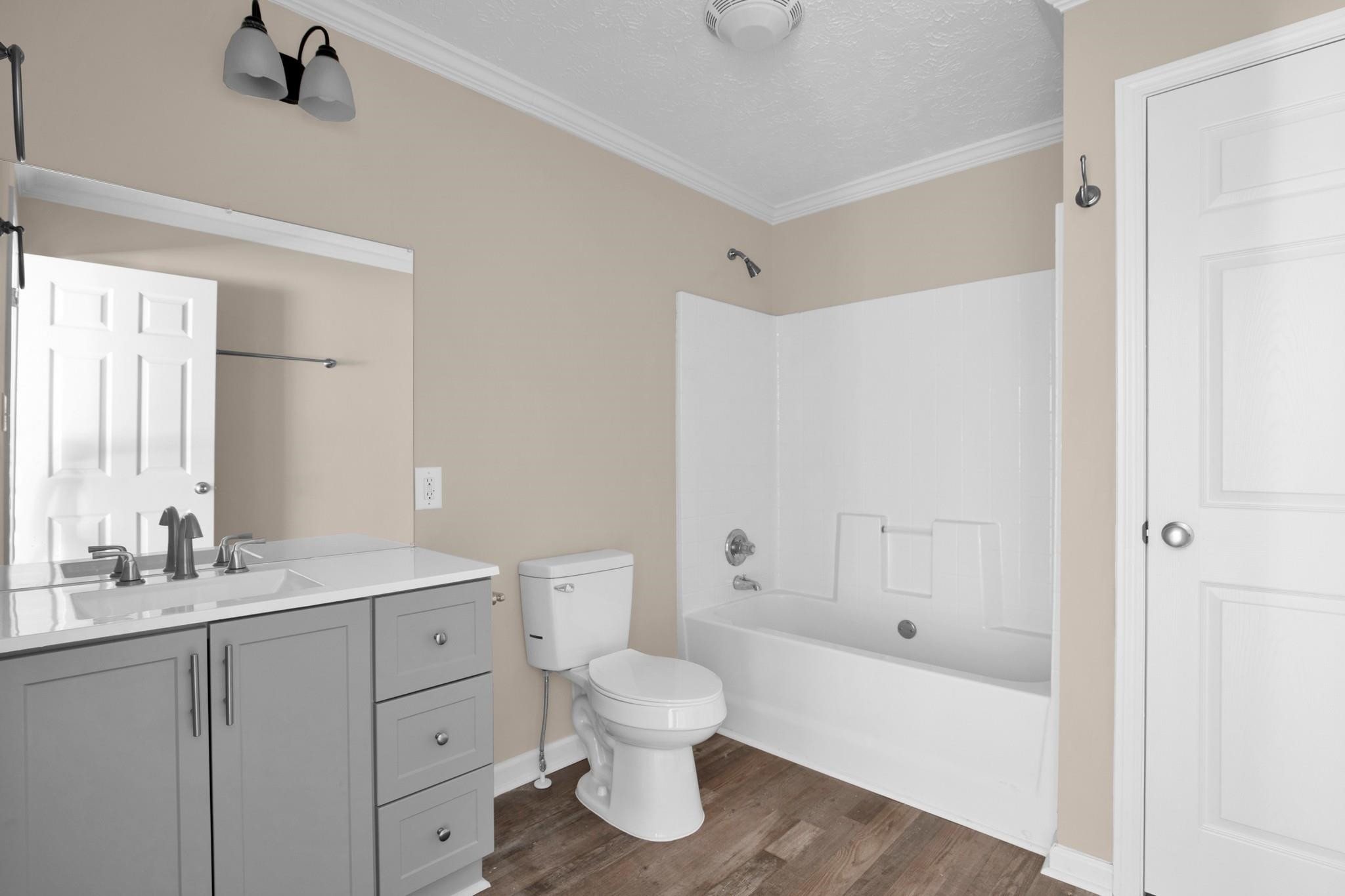 2380 Byrds Mill Road Erwin, NC 28339 - Photo 18 of 36 a bathroom with a granite countertop toilet a sink and a bathtub