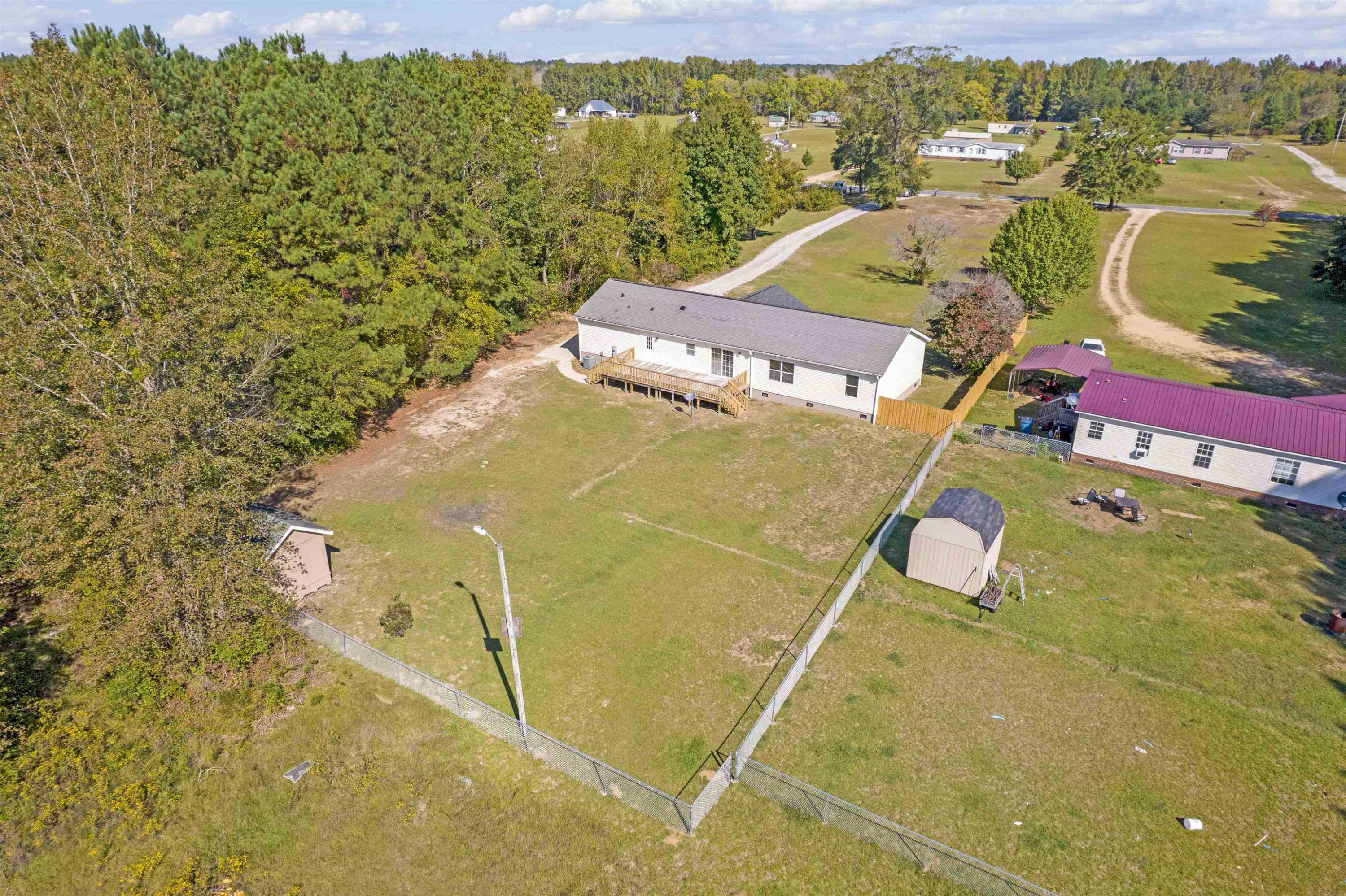 2380 Byrds Mill Road Erwin, NC 28339 - Photo 35 of 36 a view of a lake with a building in the background