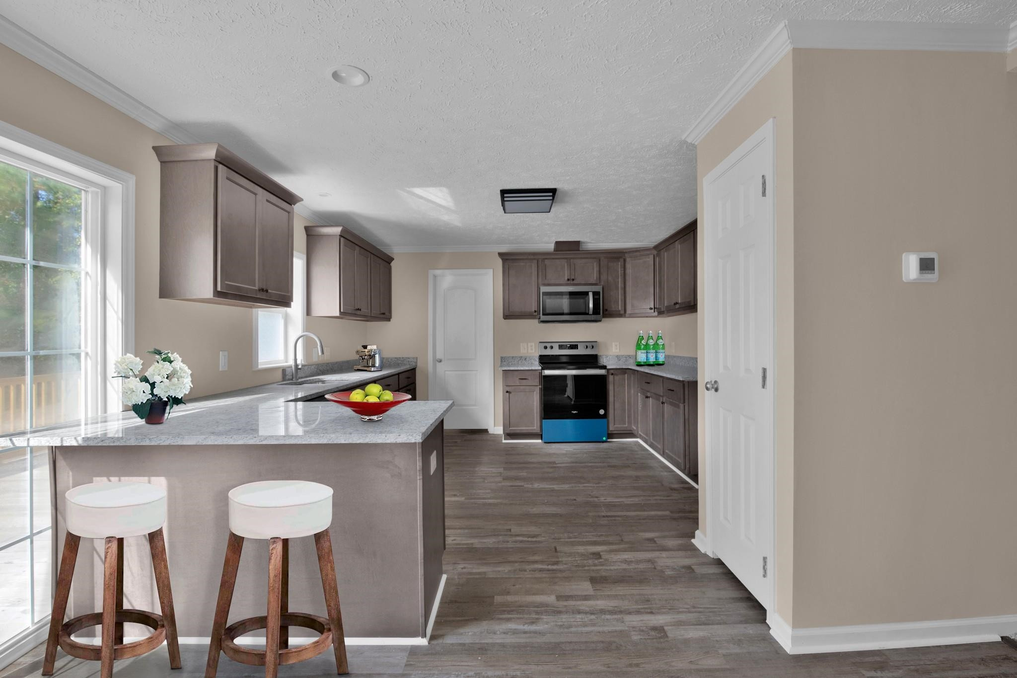 2380 Byrds Mill Road Erwin, NC 28339 - Photo 10 of 36 a kitchen with stainless steel appliances granite countertop a stove top oven a refrigerator a sink and dishwasher with white cabinets