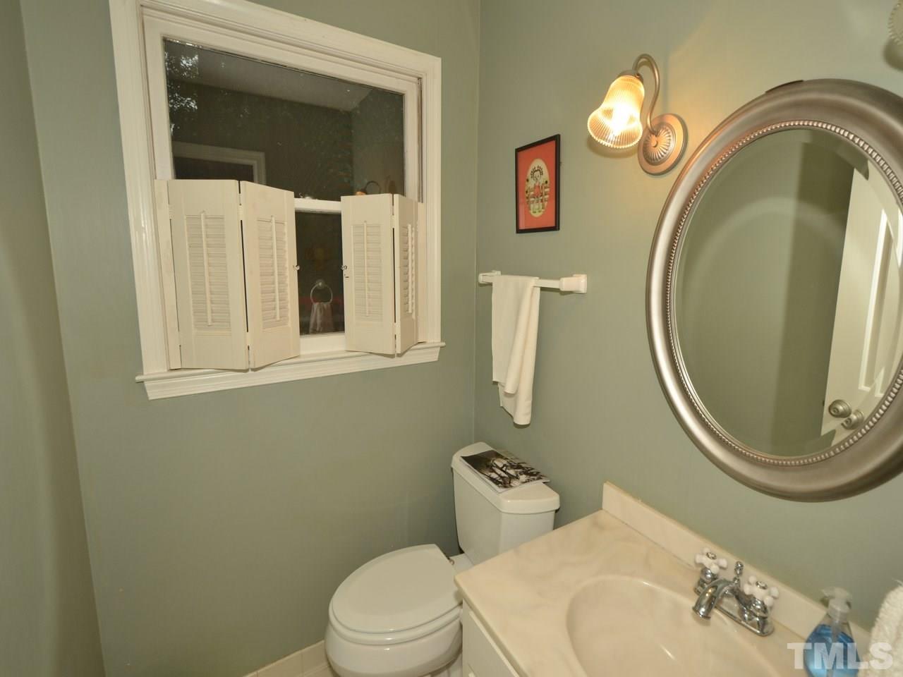 2821 Old Orchard Road Raleigh, NC 27607 - Photo 11 of 25 a bathroom with a toilet sink and mirror