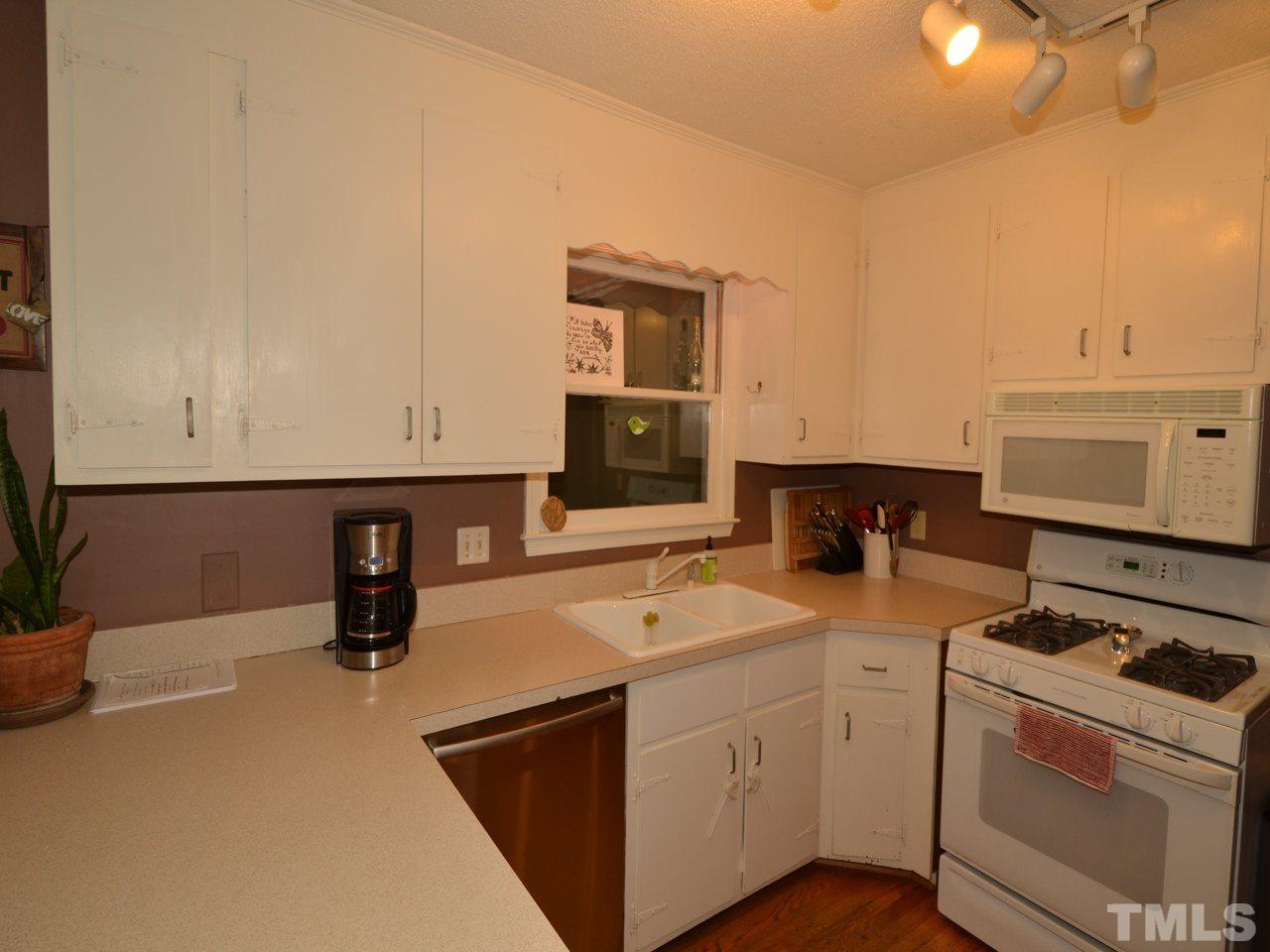 2821 Old Orchard Road Raleigh, NC 27607 - Photo 14 of 25 a kitchen with a sink cabinets and appliances