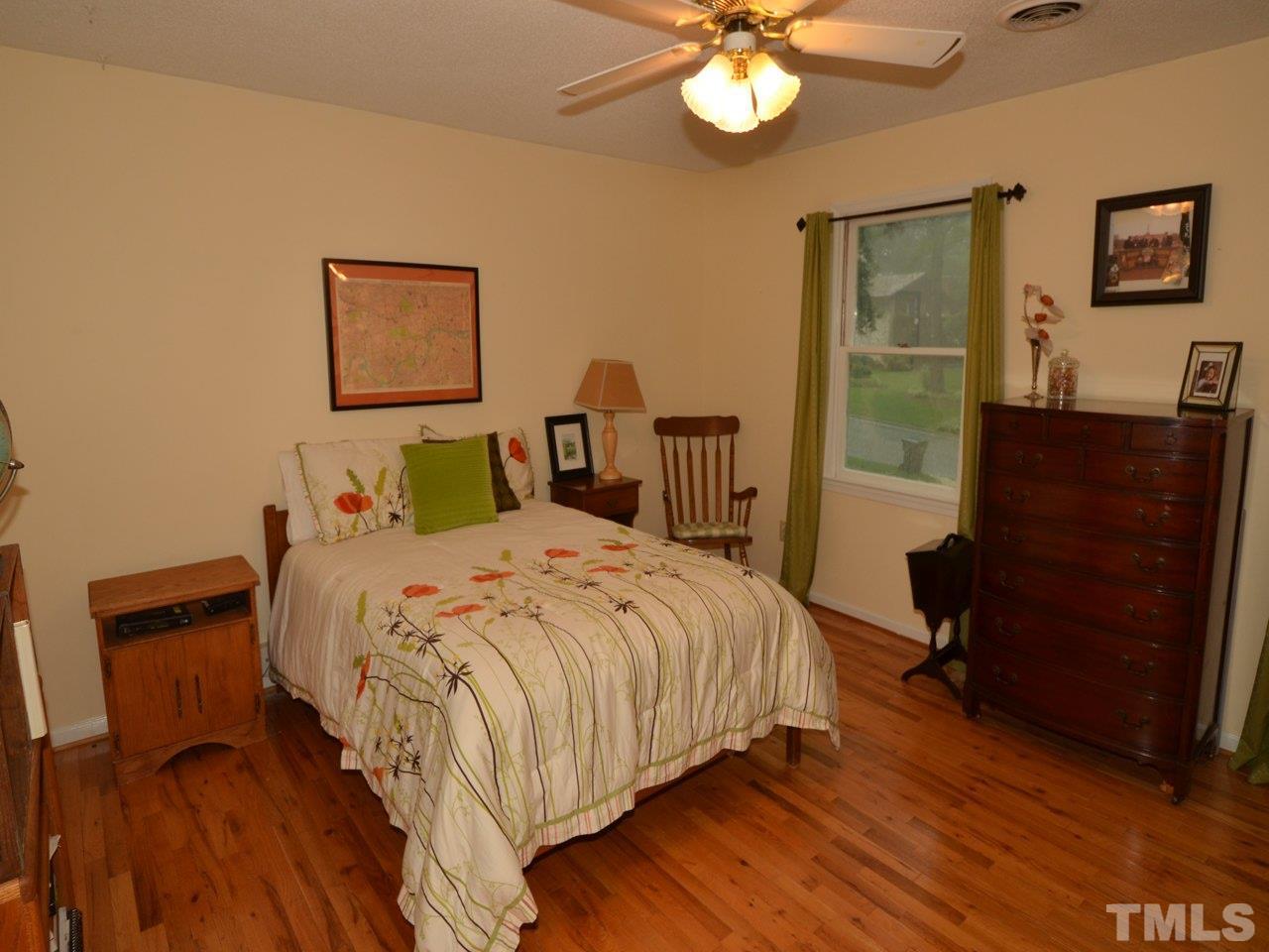 2821 Old Orchard Road Raleigh, NC 27607 - Photo 16 of 25 a bedroom with a bed and a dresser