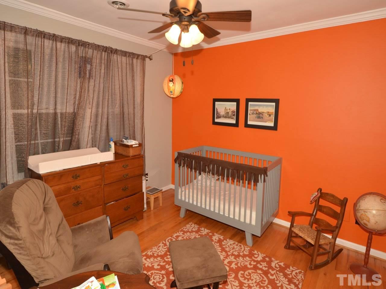 2821 Old Orchard Road Raleigh, NC 27607 - Photo 18 of 25 a view of a bedroom with furniture and a ceiling fan