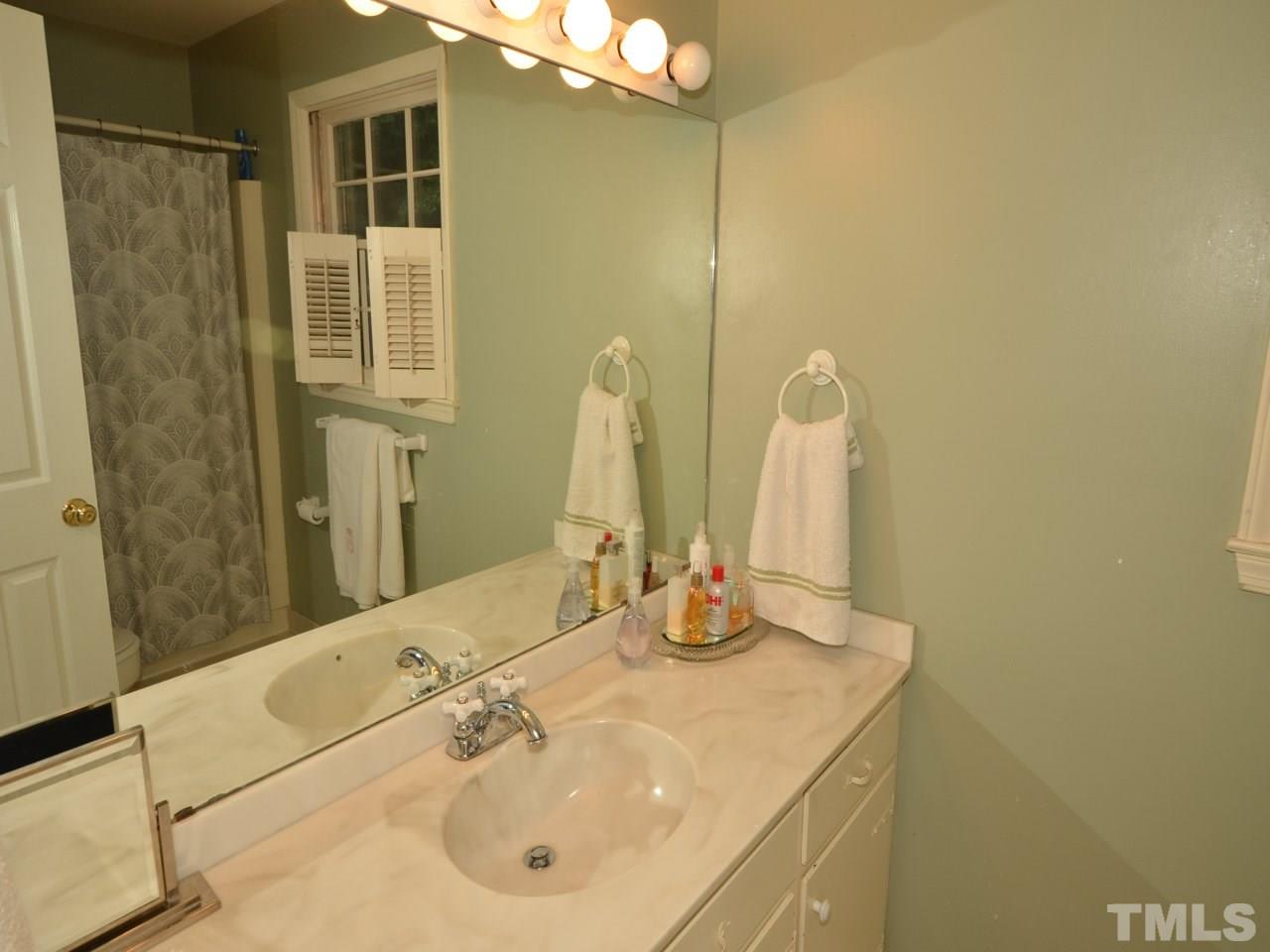 2821 Old Orchard Road Raleigh, NC 27607 - Photo 20 of 25 a bathroom with a sink and a mirror