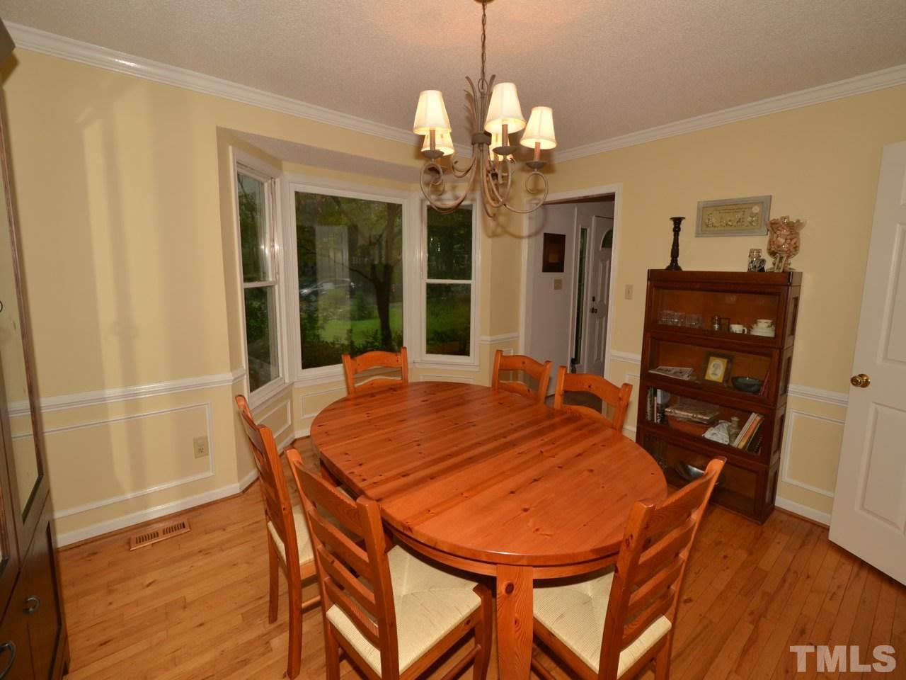 2821 Old Orchard Road Raleigh, NC 27607 - Photo 3 of 25 a view of a dining room with furniture and wooden floor