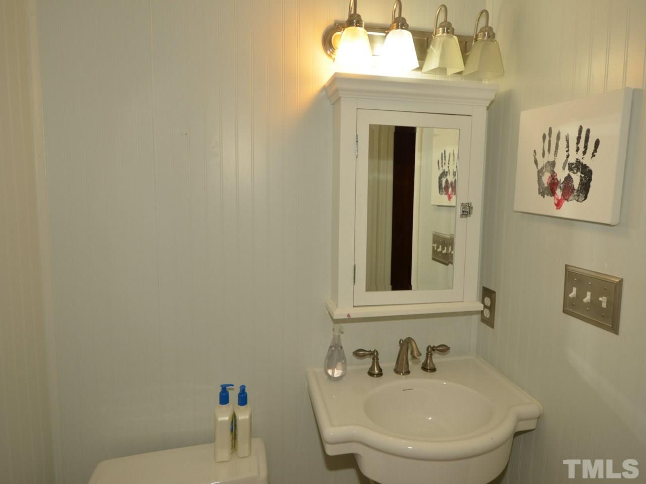 2821 Old Orchard Road Raleigh, NC 27607 - Photo 23 of 25 a bathroom with a sink and a mirror