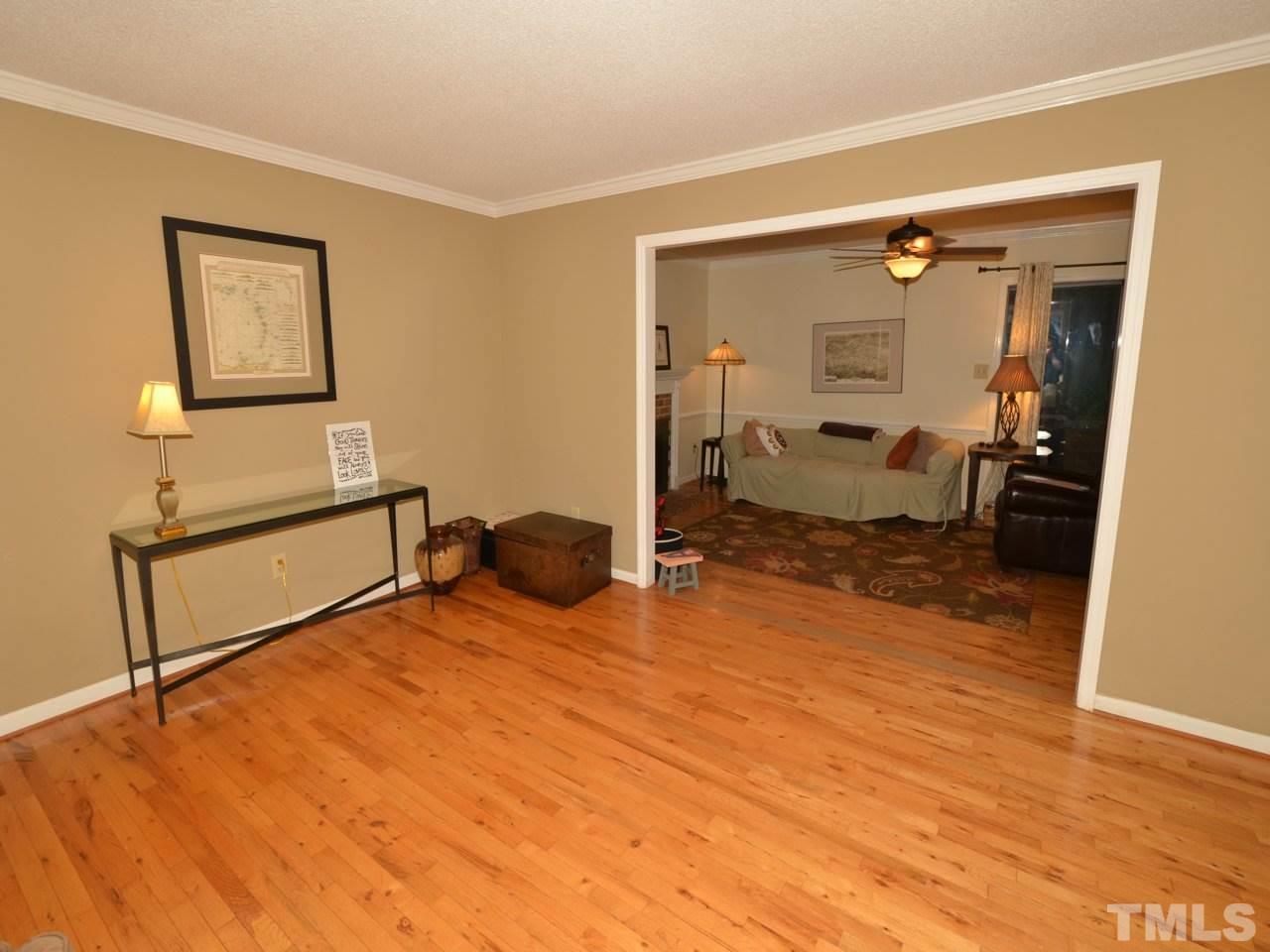 2821 Old Orchard Road Raleigh, NC 27607 - Photo 5 of 25 a bedroom with a bed and wooden floor