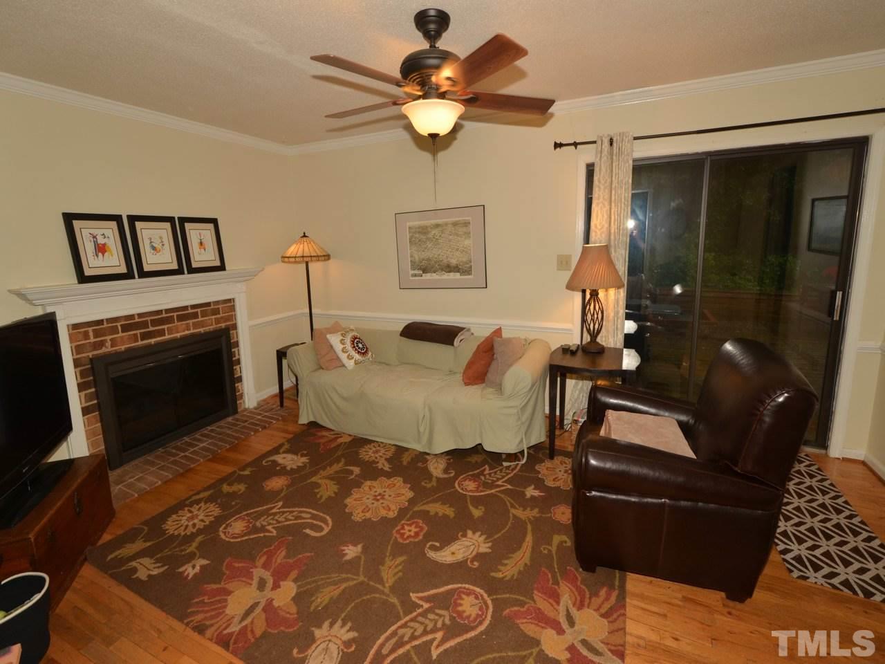2821 Old Orchard Road Raleigh, NC 27607 - Photo 7 of 25 a living room with furniture and a fireplace