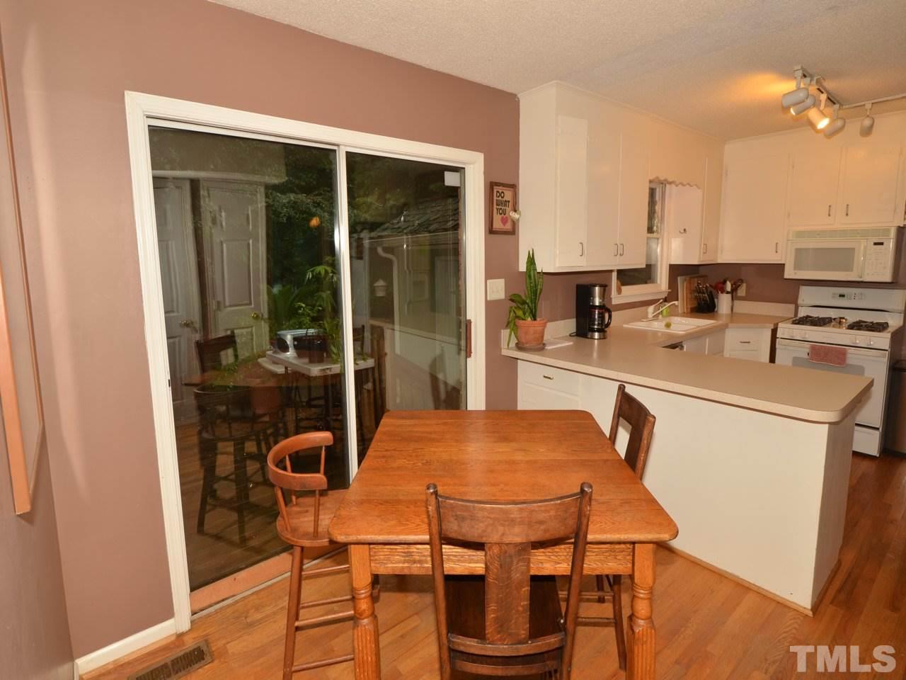 2821 Old Orchard Road Raleigh, NC 27607 - Photo 9 of 25 a dining room with furniture and wooden floor