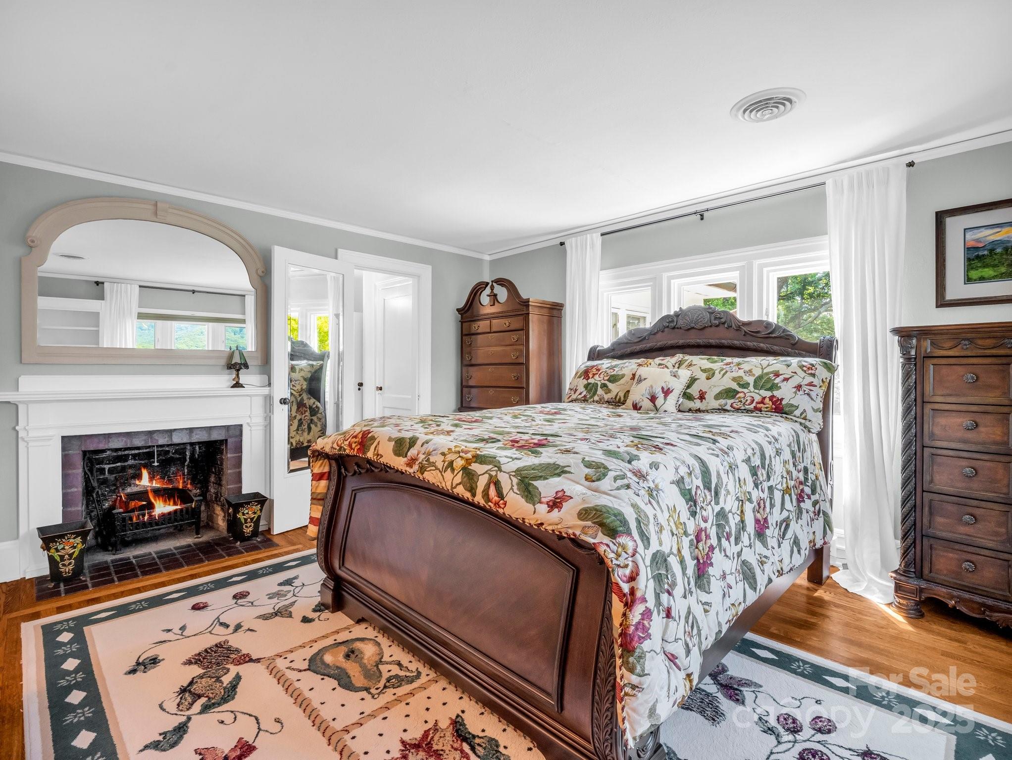 287 Pacolet Ridge Lane Tryon, NC 28782 - Photo 26 of 48 a bedroom with a bed and a fireplace