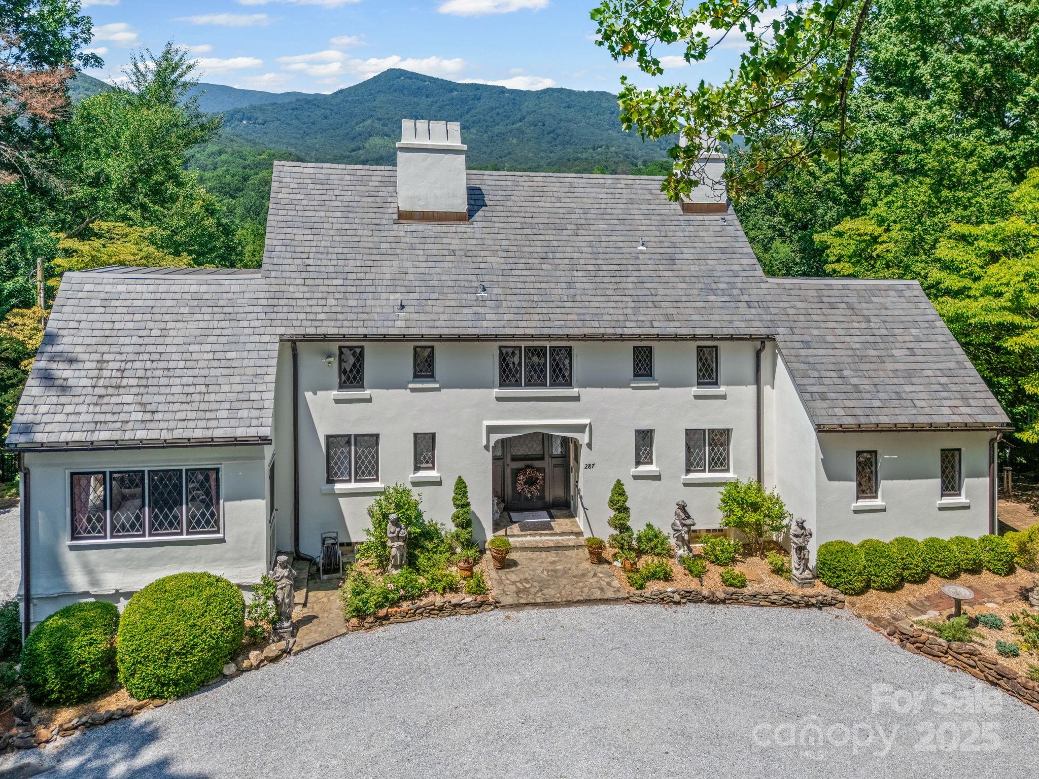 287 Pacolet Ridge Lane Tryon, NC 28782 - Photo 3 of 48 a front view of a house with a garden