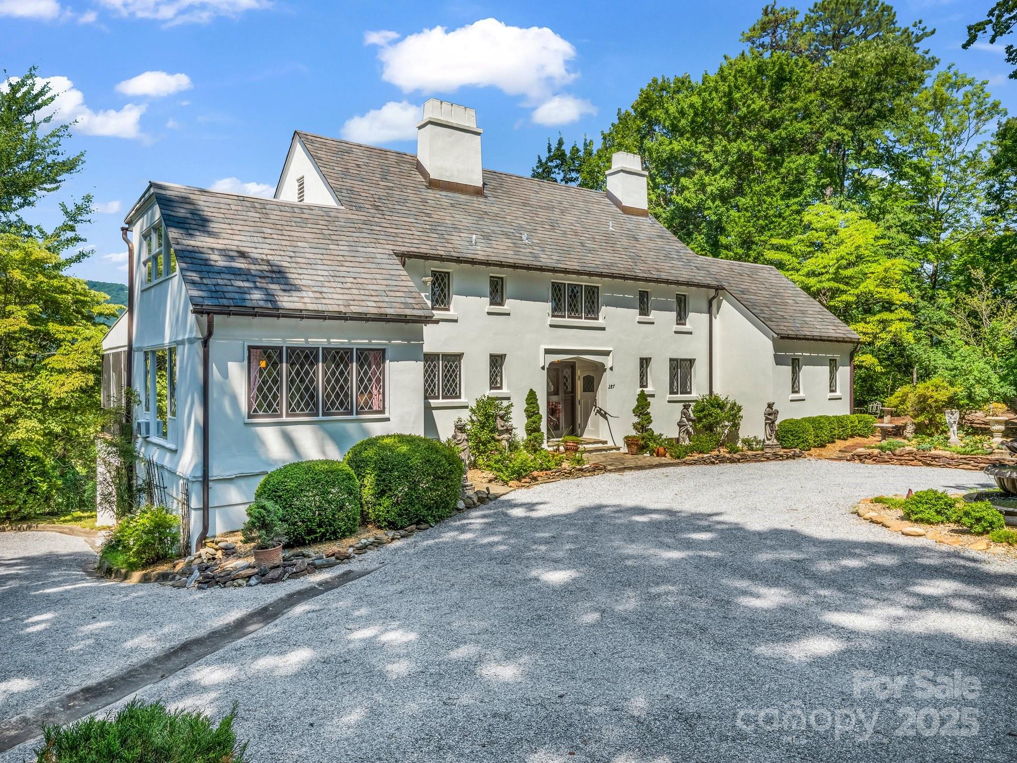 287 Pacolet Ridge Lane Tryon, NC 28782 - Photo 44 of 48 a front view of a house with a yard and potted plants