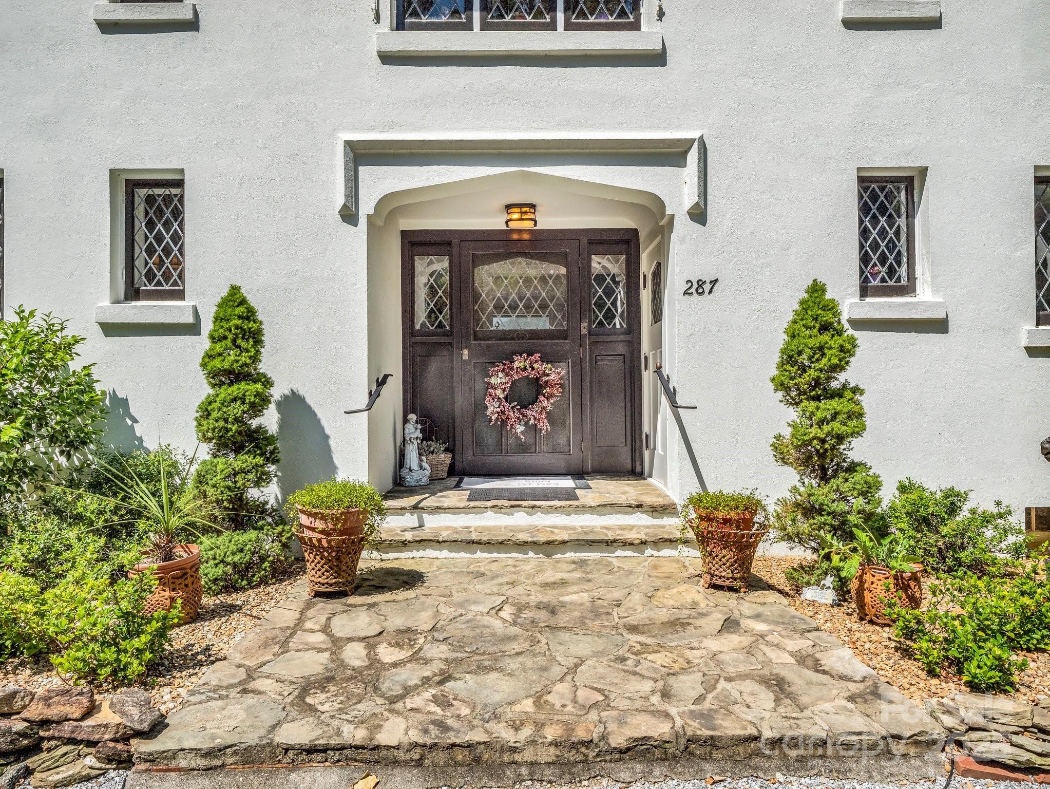 287 Pacolet Ridge Lane Tryon, NC 28782 - Photo 5 of 48 a front view of a house with garden