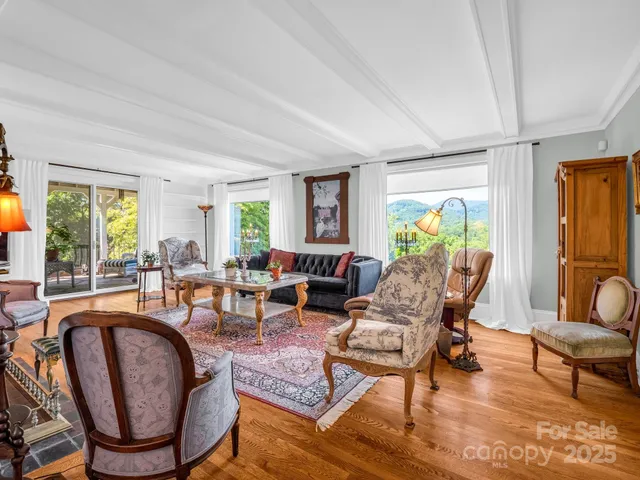 a vase of flowers sitting on a table with window