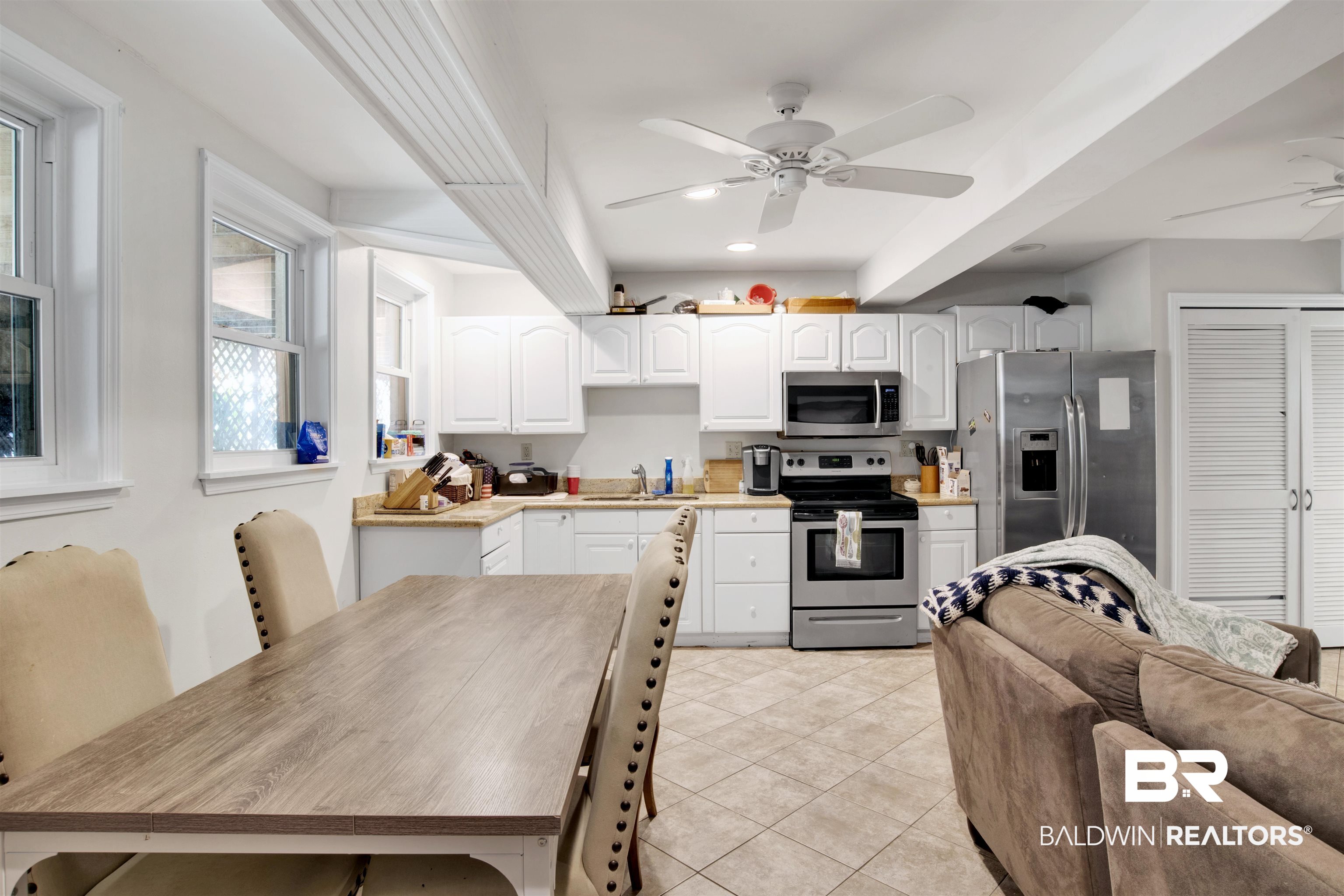 605 Van Avenue Daphne, AL 36526 - Photo 25 of 37 Kitchen with sink, white cabinets, light tile patterned flooring, appliances with stainless steel finishes, and ceiling fan