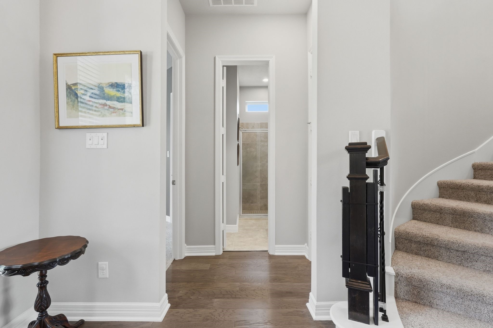 27705 South Slate Hills Lane Spring, TX 77386 - Photo 5 of 45 Downstairs hallway leading to a versatile, multi-functional living layout. The full bathroom is straight ahead, and the first bedroom, which has been used as an office, is to the left of the bathroom.