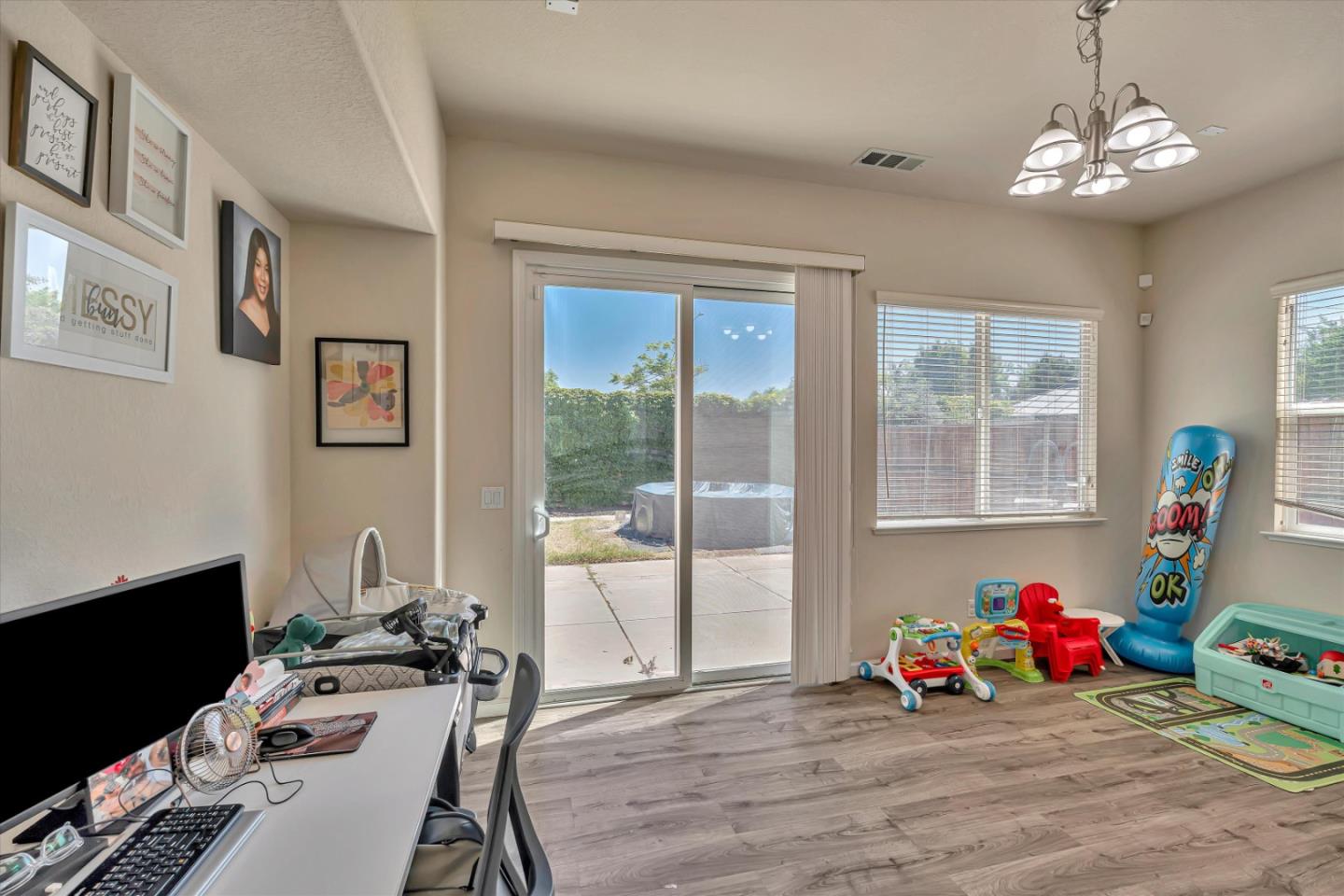 390 Munter Street Manteca, CA 95337 - Photo 11 of 26 a bedroom with furniture and a chandelier
