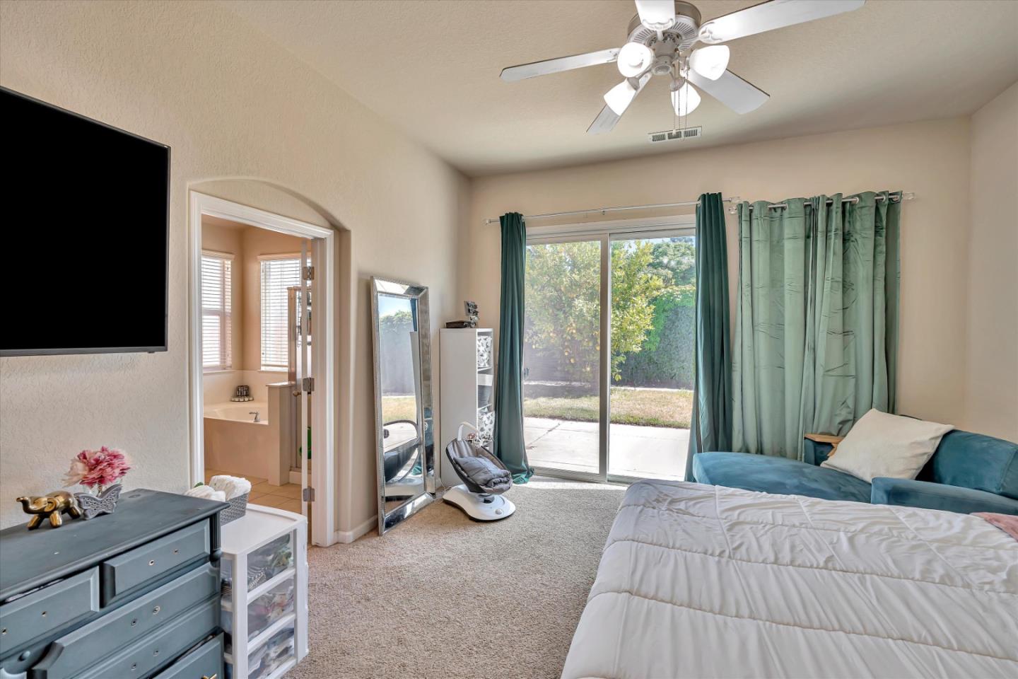 390 Munter Street Manteca, CA 95337 - Photo 15 of 26 a bedroom with a bed and large windows
