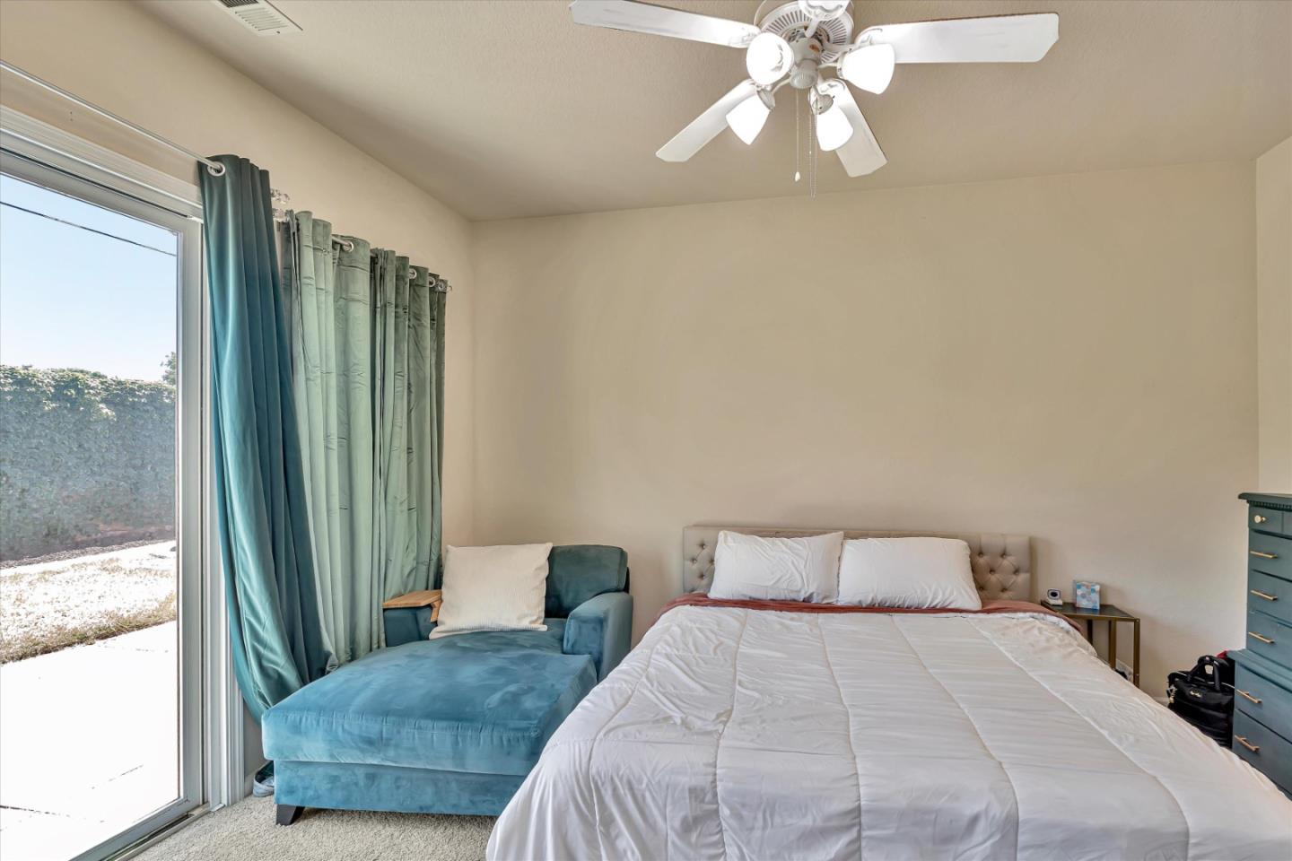 390 Munter Street Manteca, CA 95337 - Photo 17 of 26 a bedroom with a large bed and a chandelier