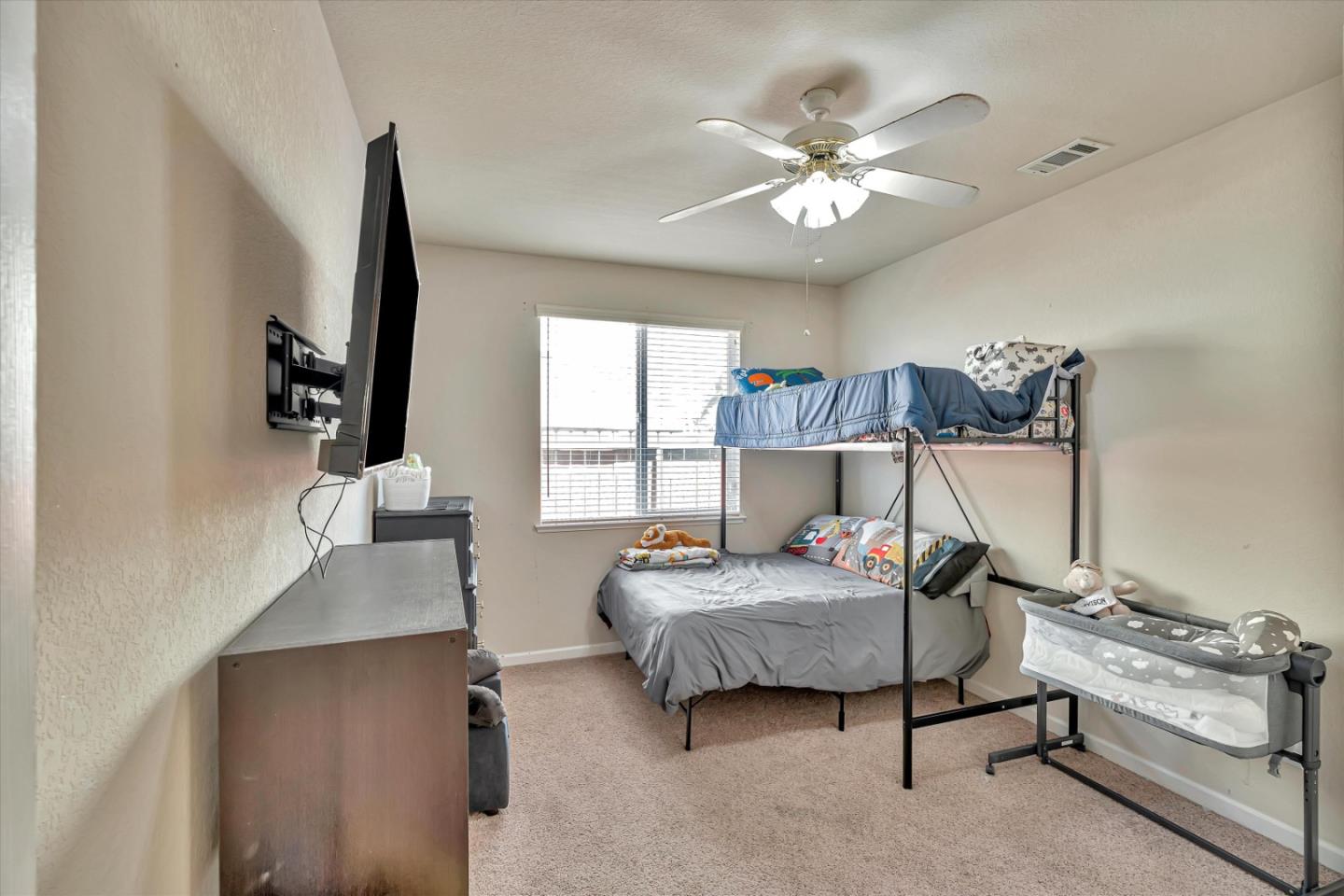 390 Munter Street Manteca, CA 95337 - Photo 18 of 26 a bedroom with a bed and a chandelier