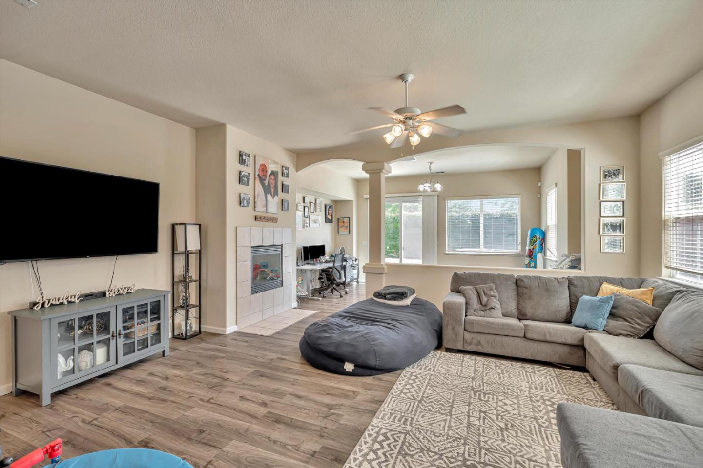 390 Munter Street Manteca, CA 95337 - Photo 2 of 26 a living room with furniture and a flat screen tv