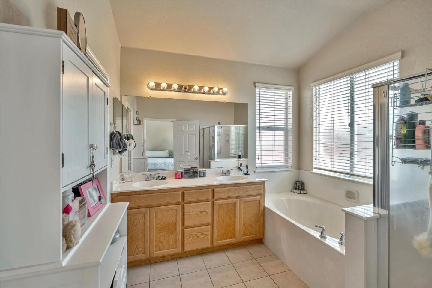 390 Munter Street Manteca, CA 95337 - Photo 21 of 26 a bathroom with a tub sink and mirror