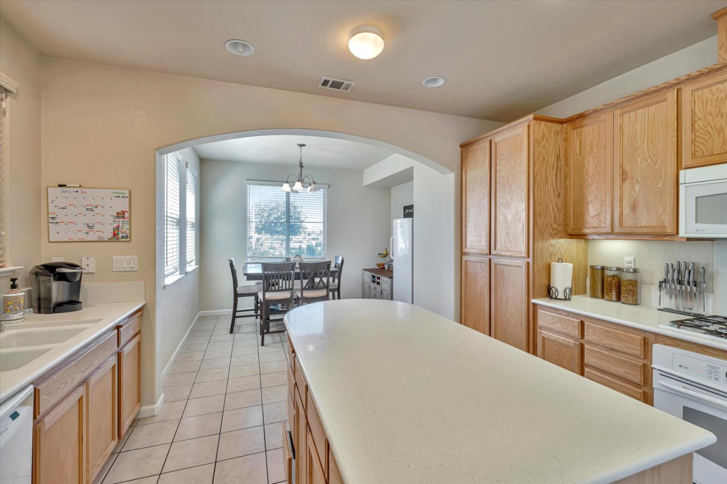 390 Munter Street Manteca, CA 95337 - Photo 5 of 26 a large white kitchen with cabinets