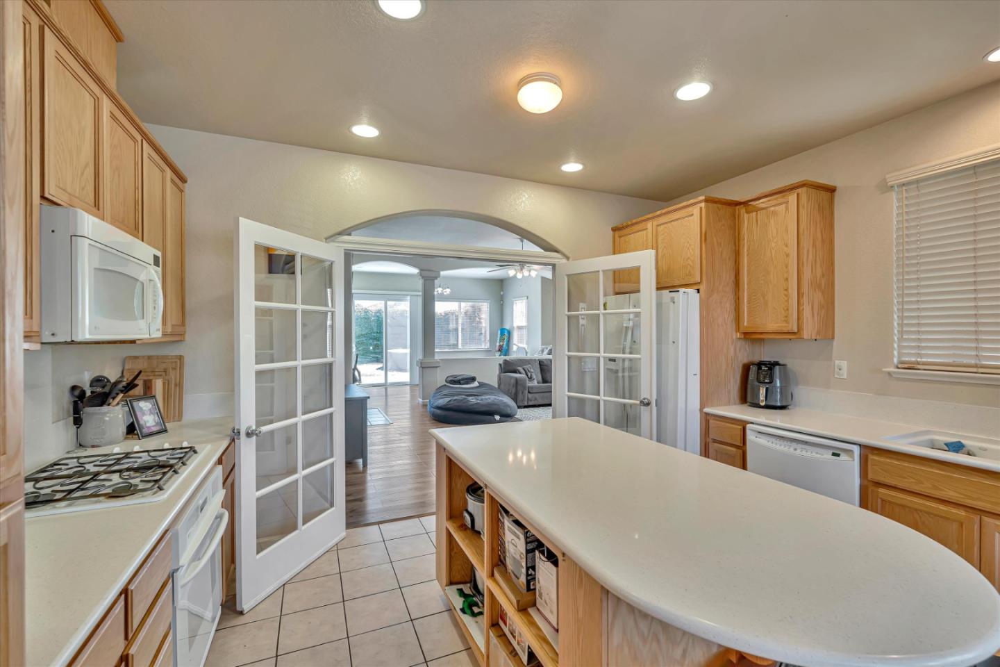 390 Munter Street Manteca, CA 95337 - Photo 6 of 26 a large kitchen with kitchen island a sink a stove and a refrigerator