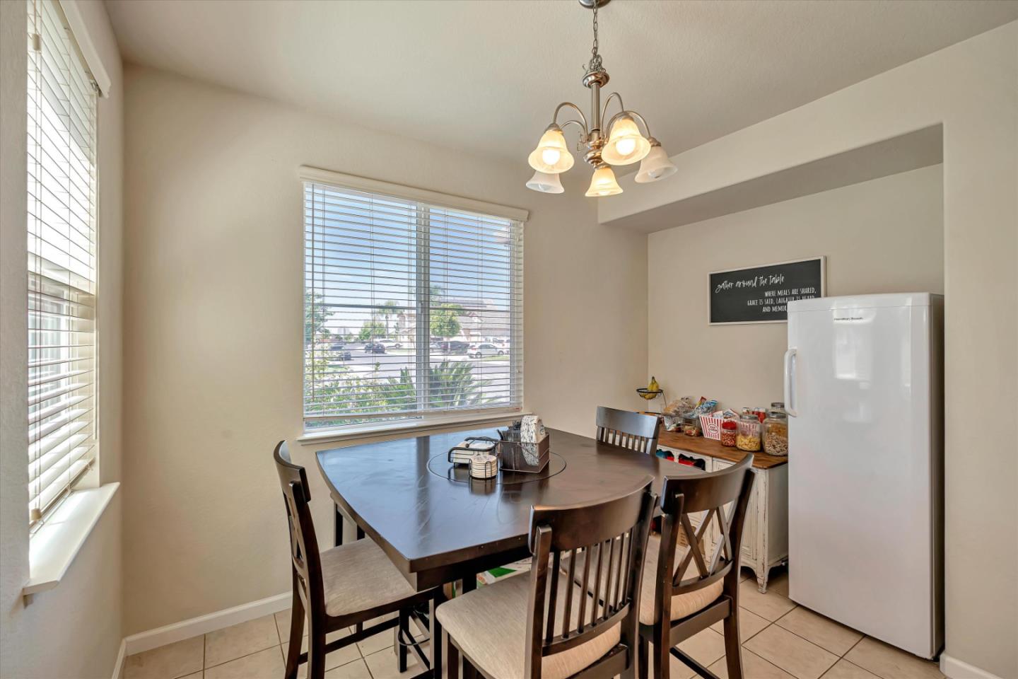 390 Munter Street Manteca, CA 95337 - Photo 8 of 26 a view of a dining room with furniture window and wooden floor