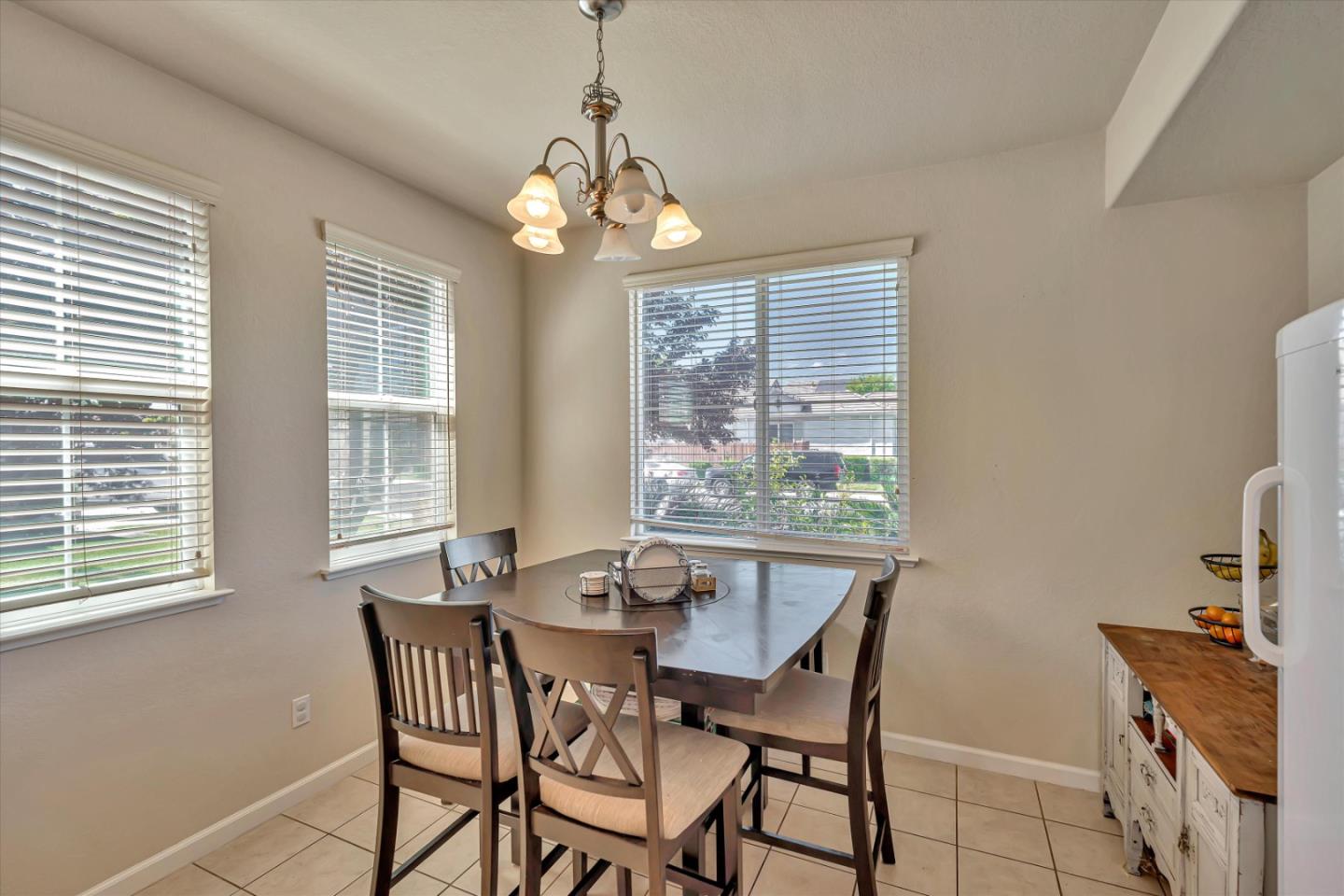 390 Munter Street Manteca, CA 95337 - Photo 10 of 26 a view of a dining room with furniture wooden floor and chandelier