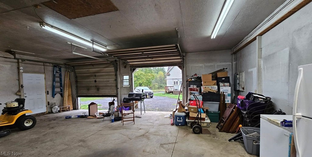 1195 South Johnson Road Sebring, OH 44672 - Photo 29 of 34 Garage with freestanding refrigerator and white fridge