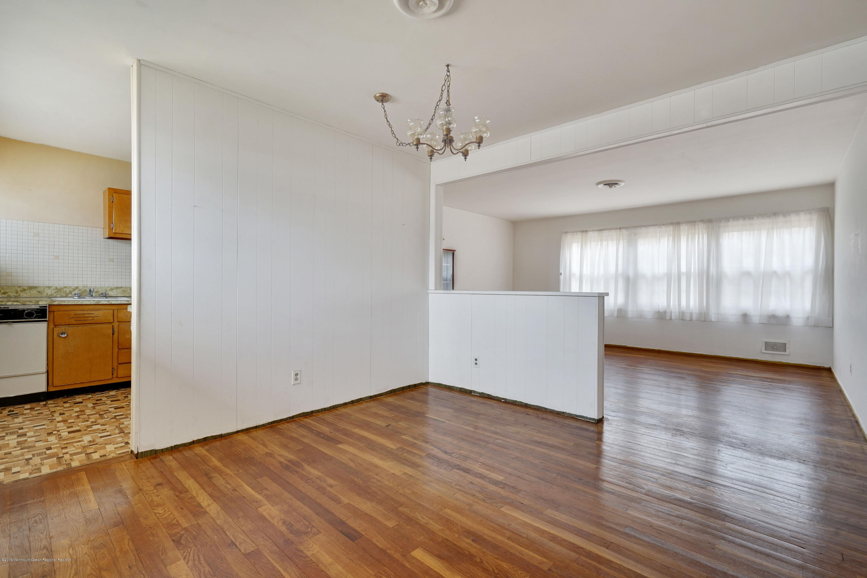 186 Princeton Road Old Bridge, NJ 08859 - Photo 8 of 20 a view of an empty room with window and wooden floor