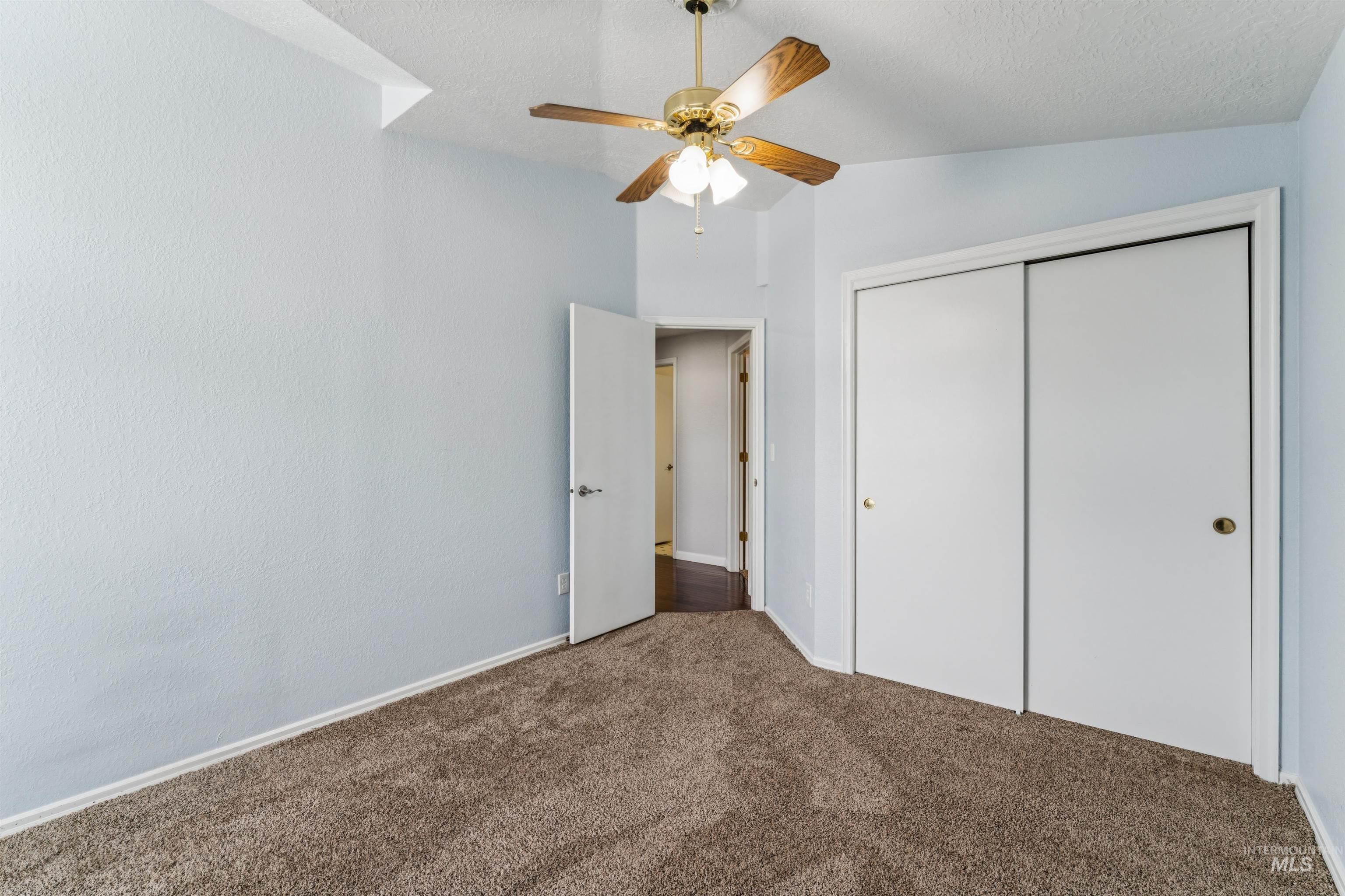 9831 West Ripley Street Boise, ID 83704 - Photo 31 of 47 Spacious room featuring light-toned plank-style flooring, a ceiling fan with integrated lighting, and built-in corner shelving